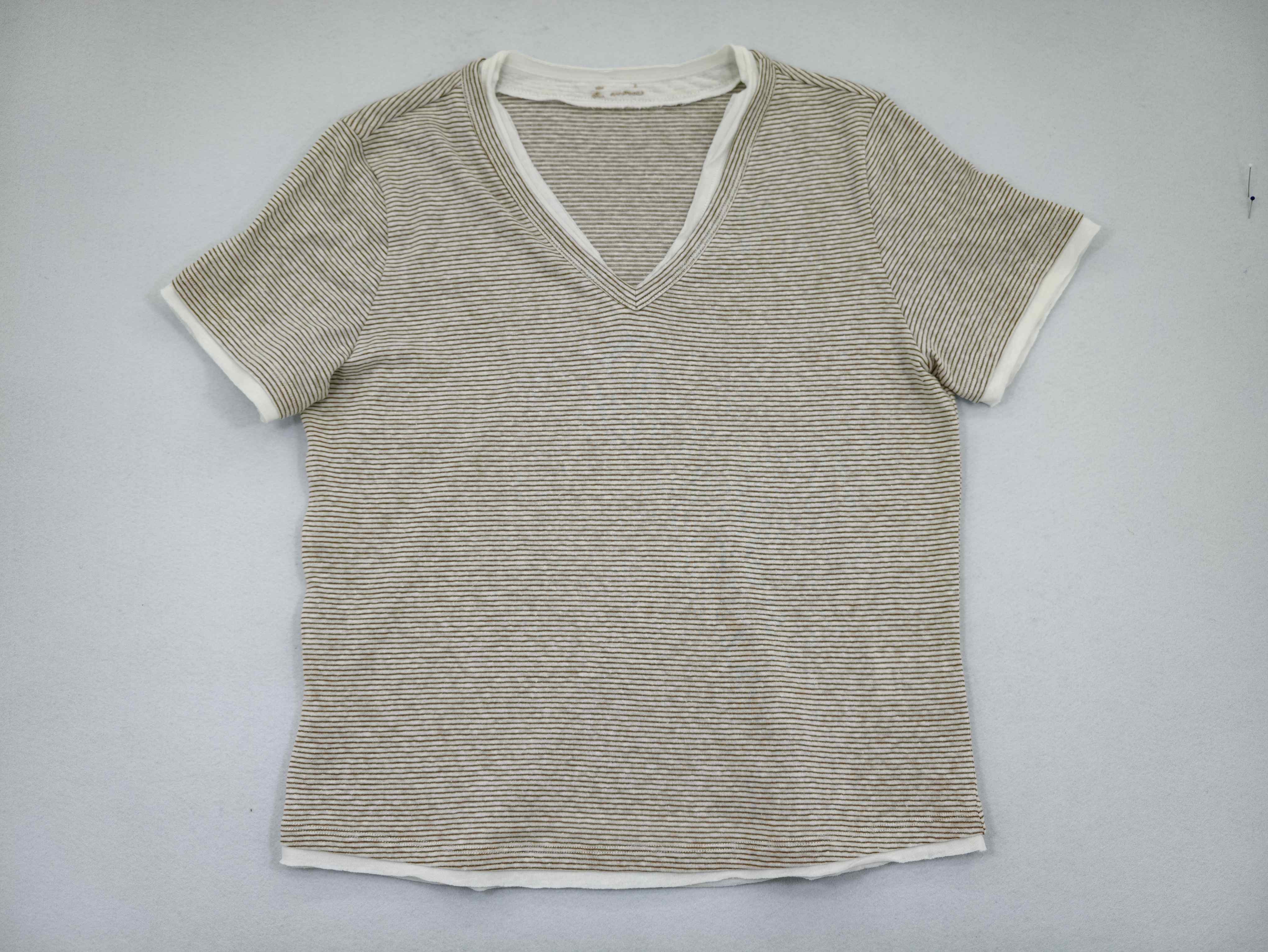 Neutral micro-stripe V-neck T-shirt laid flat from front