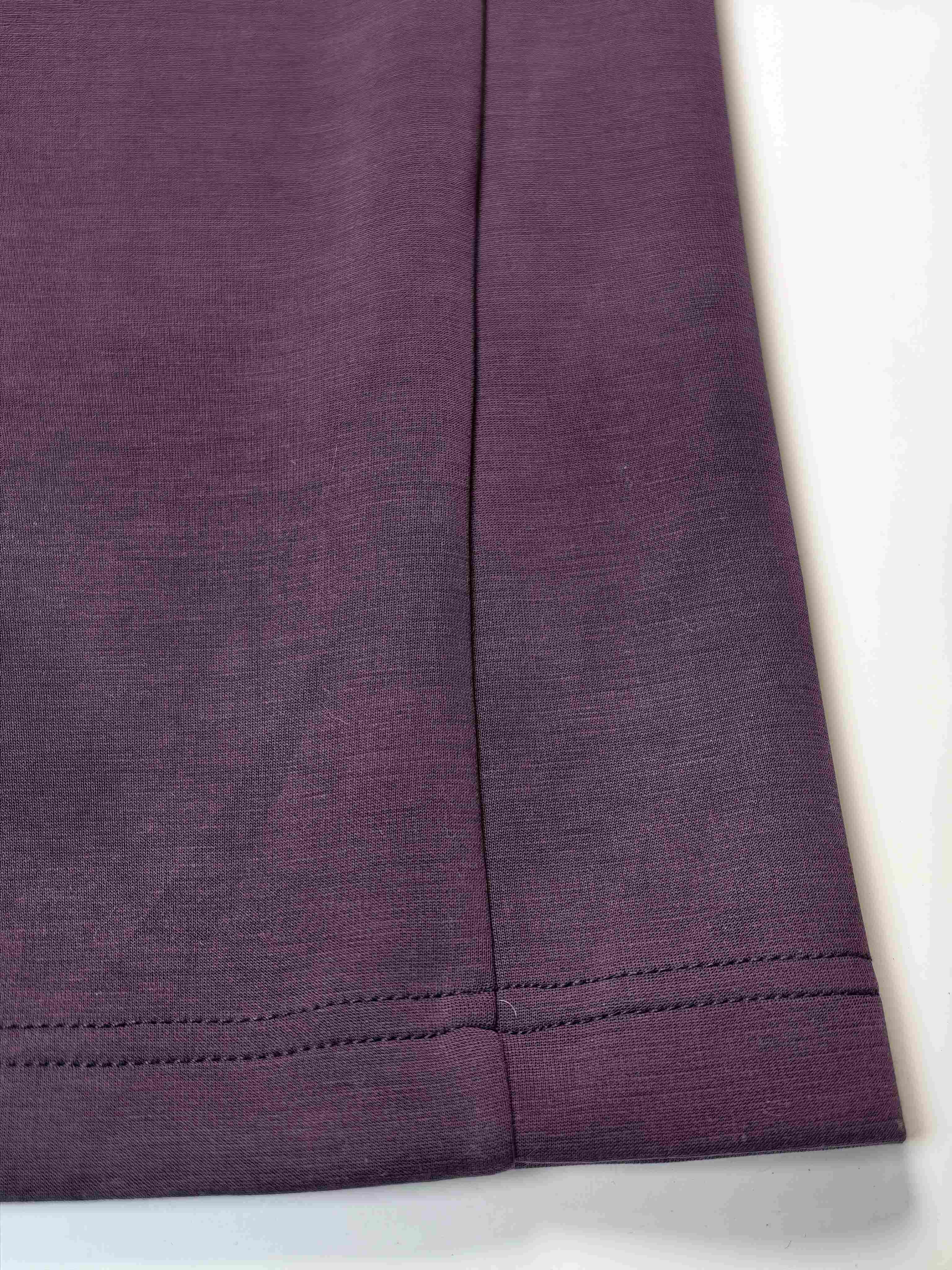 Purple knit fabric and hem stitching close-up