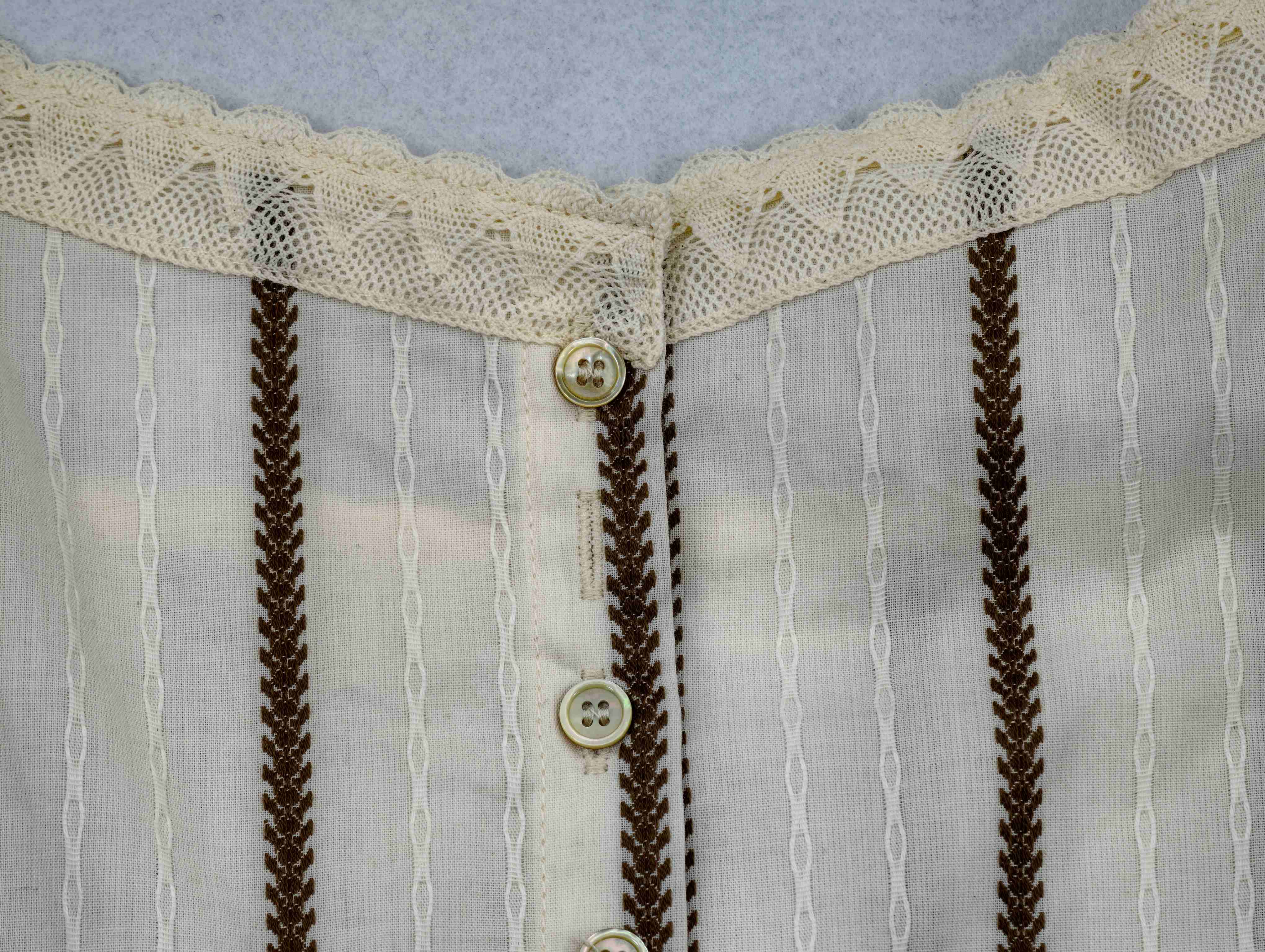 Lace neckline and button placket on striped cotton fabric