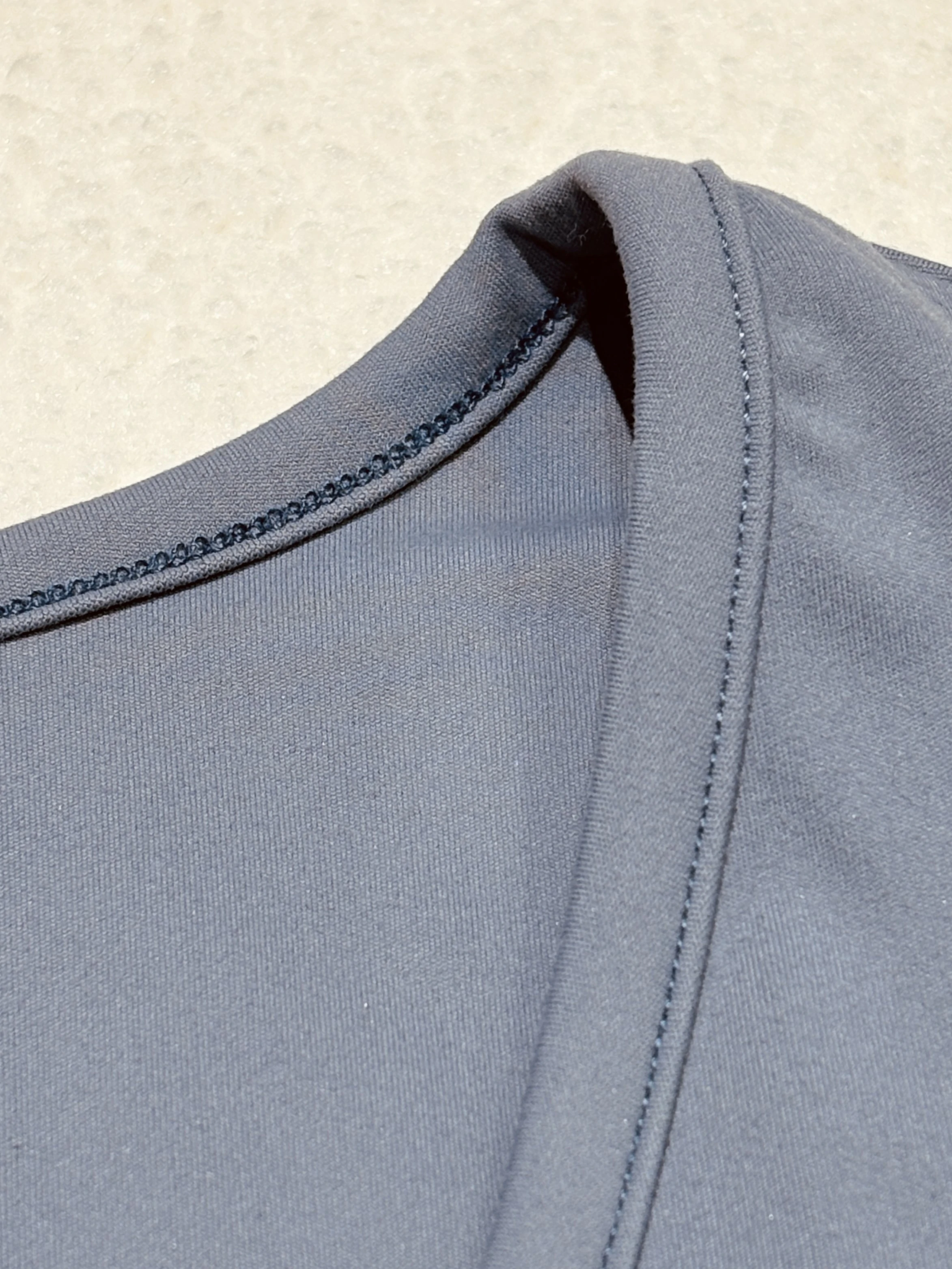Stretch neckline seam and wrap-edge construction close-up