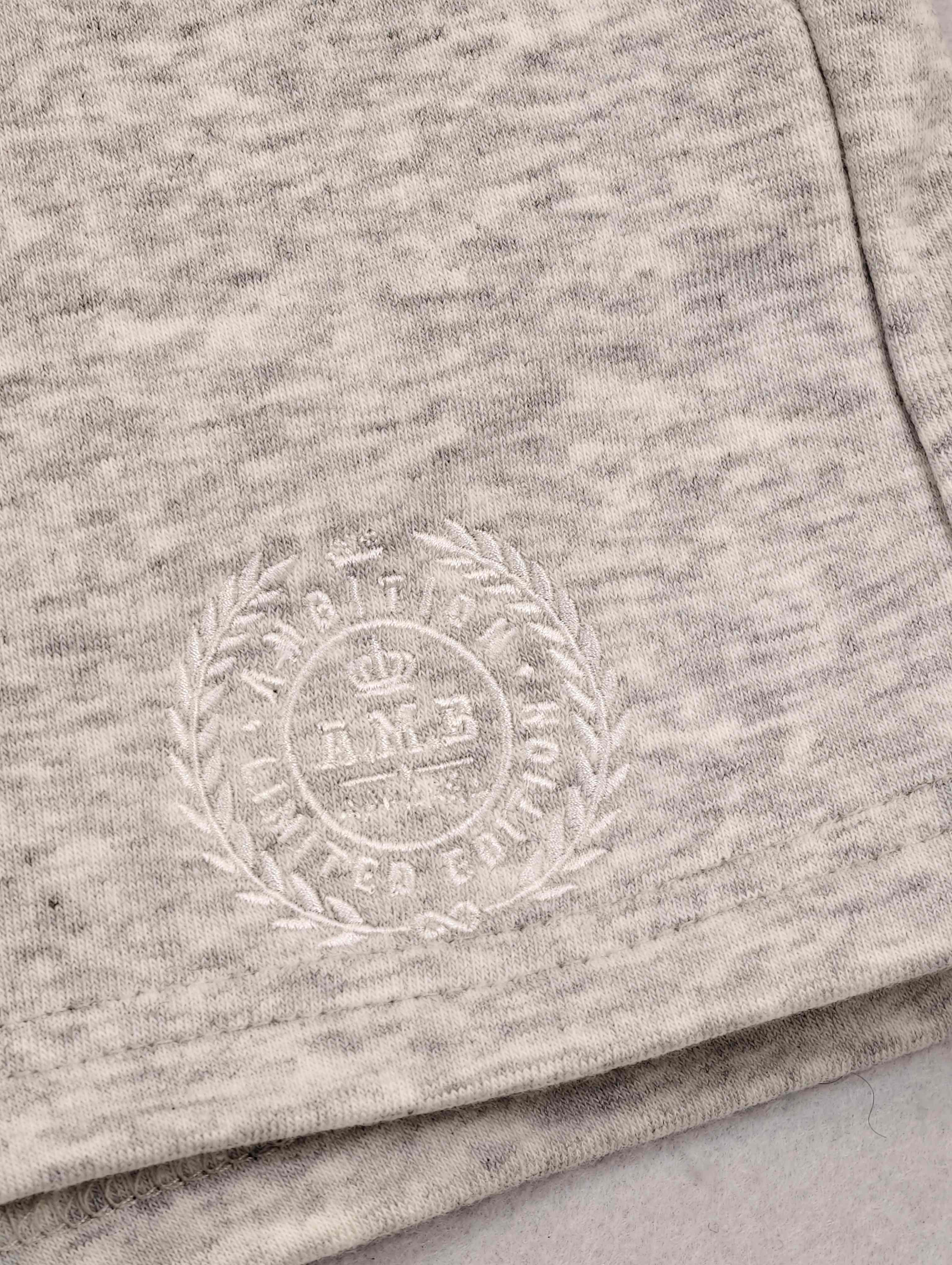 Tonal crest embroidery on cotton-modal knit fabric
