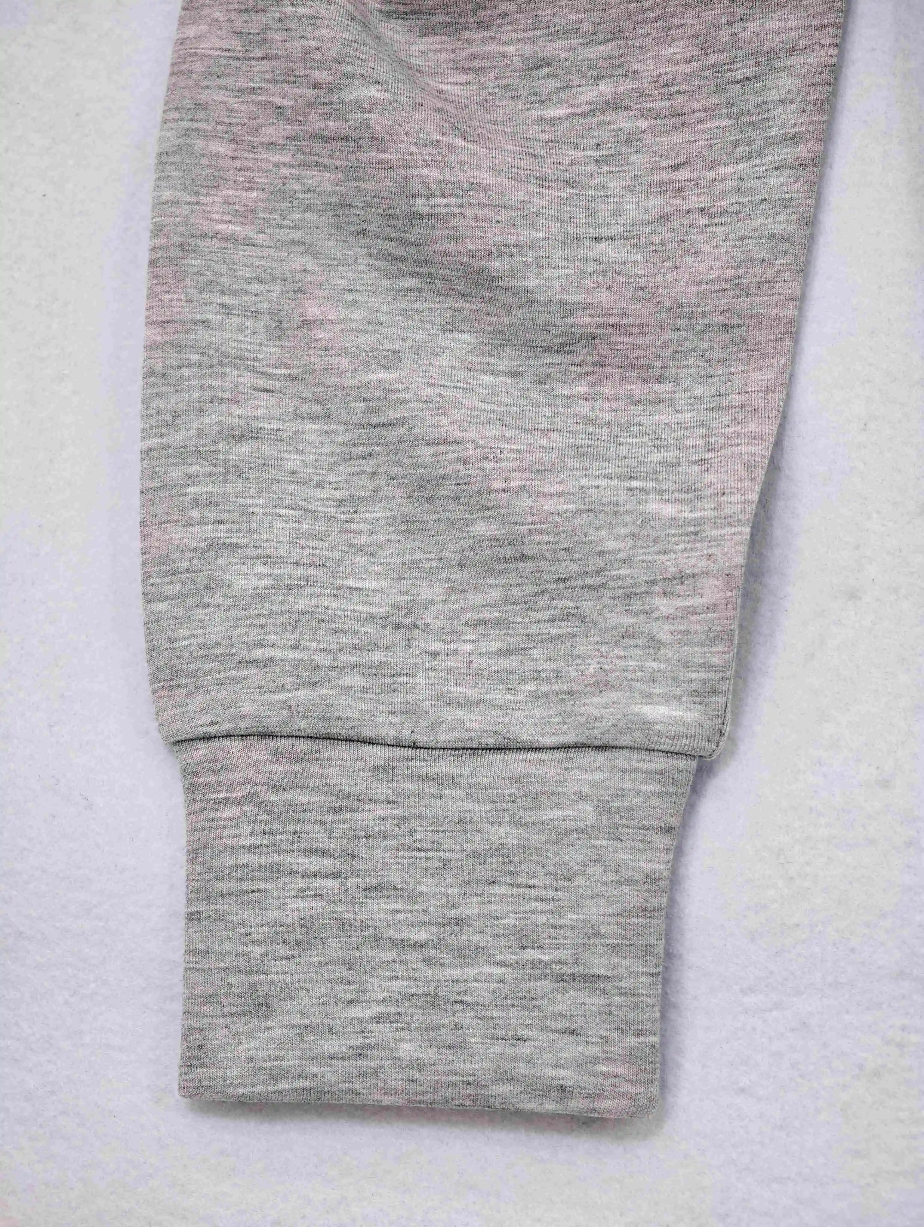 Ribbed cuff and sleeve stitching on grey sweatshirt