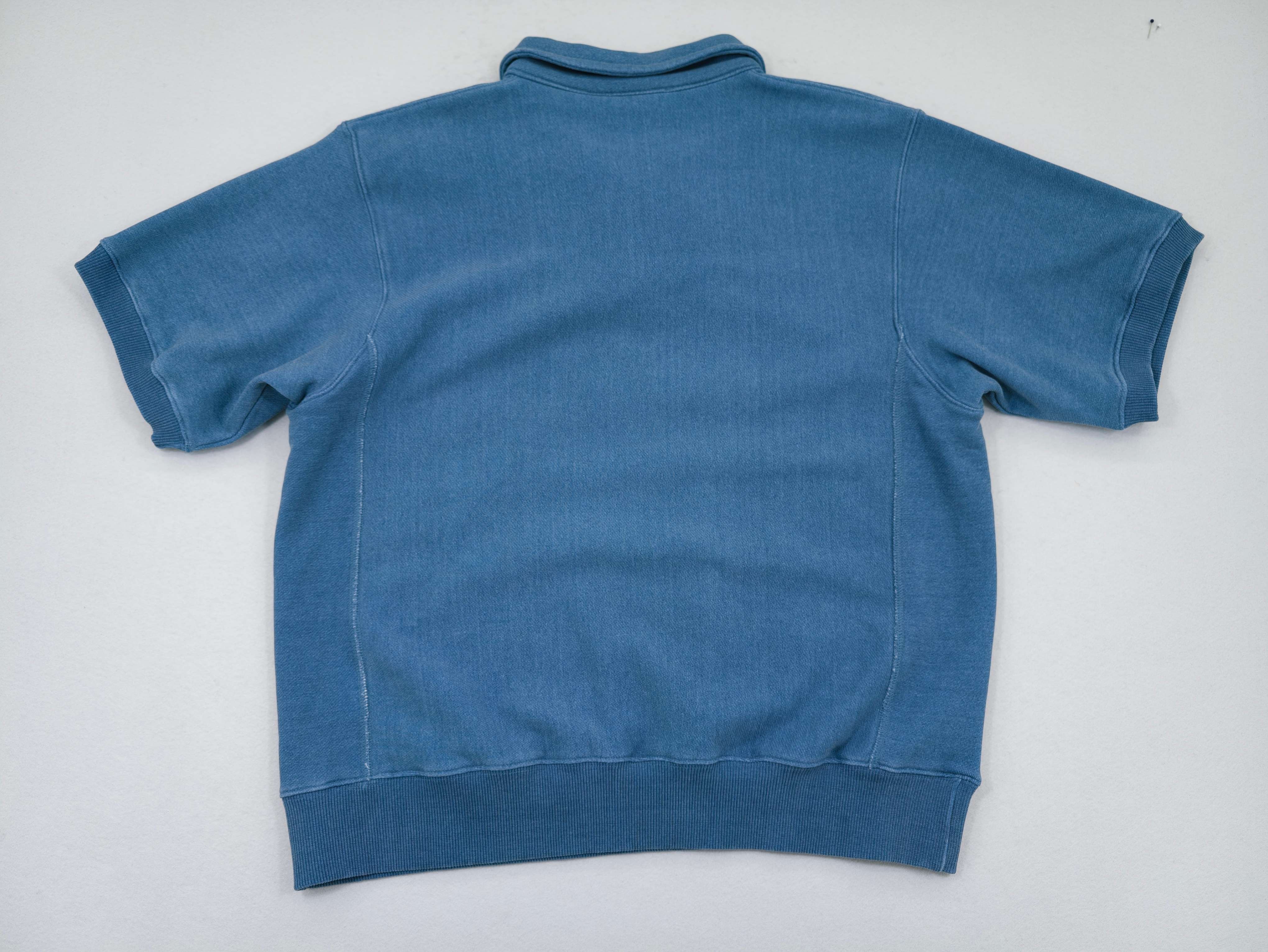 Back view of relaxed knit denim polo pullover