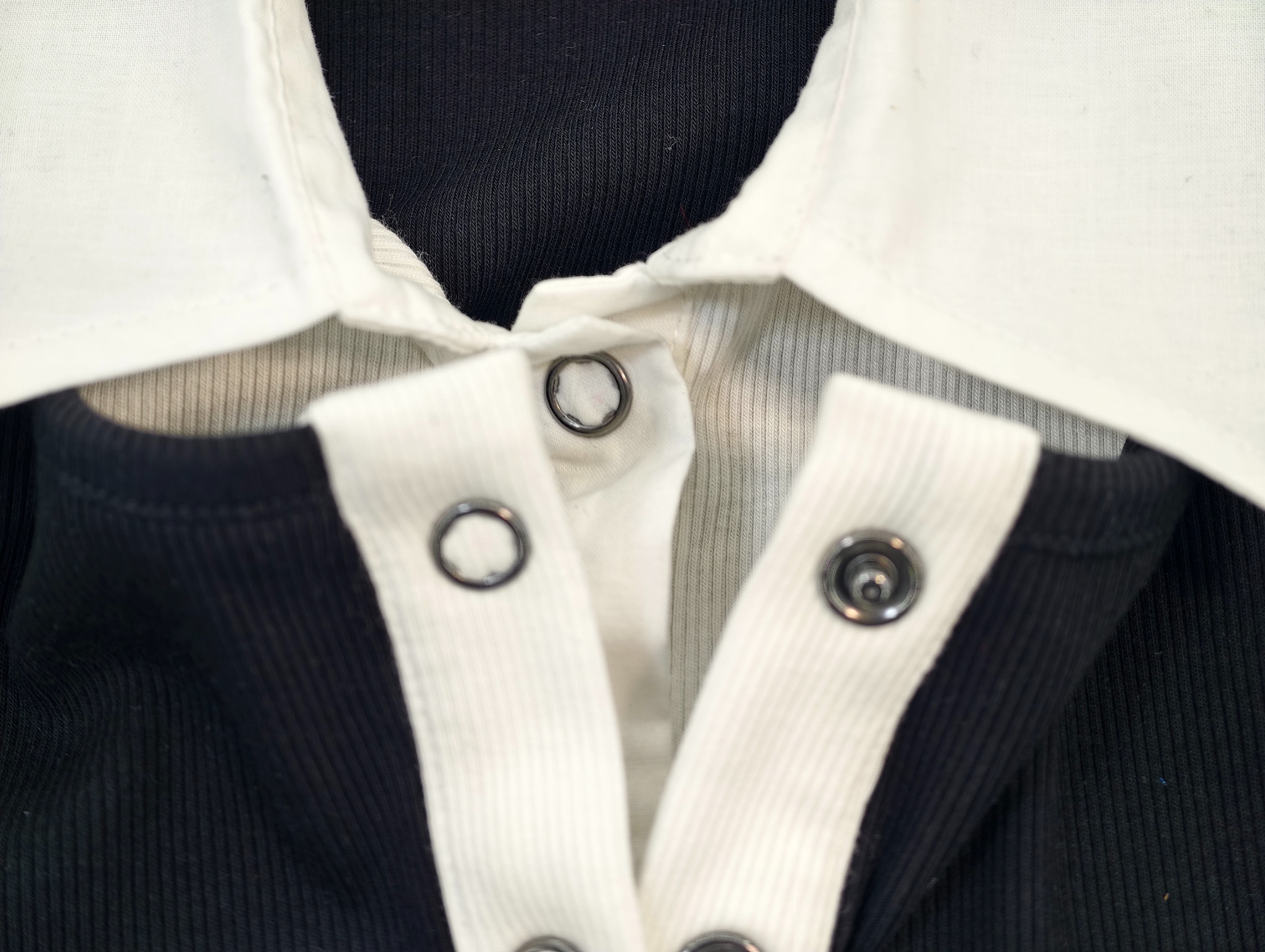 White button placket with metal snap closures close-up