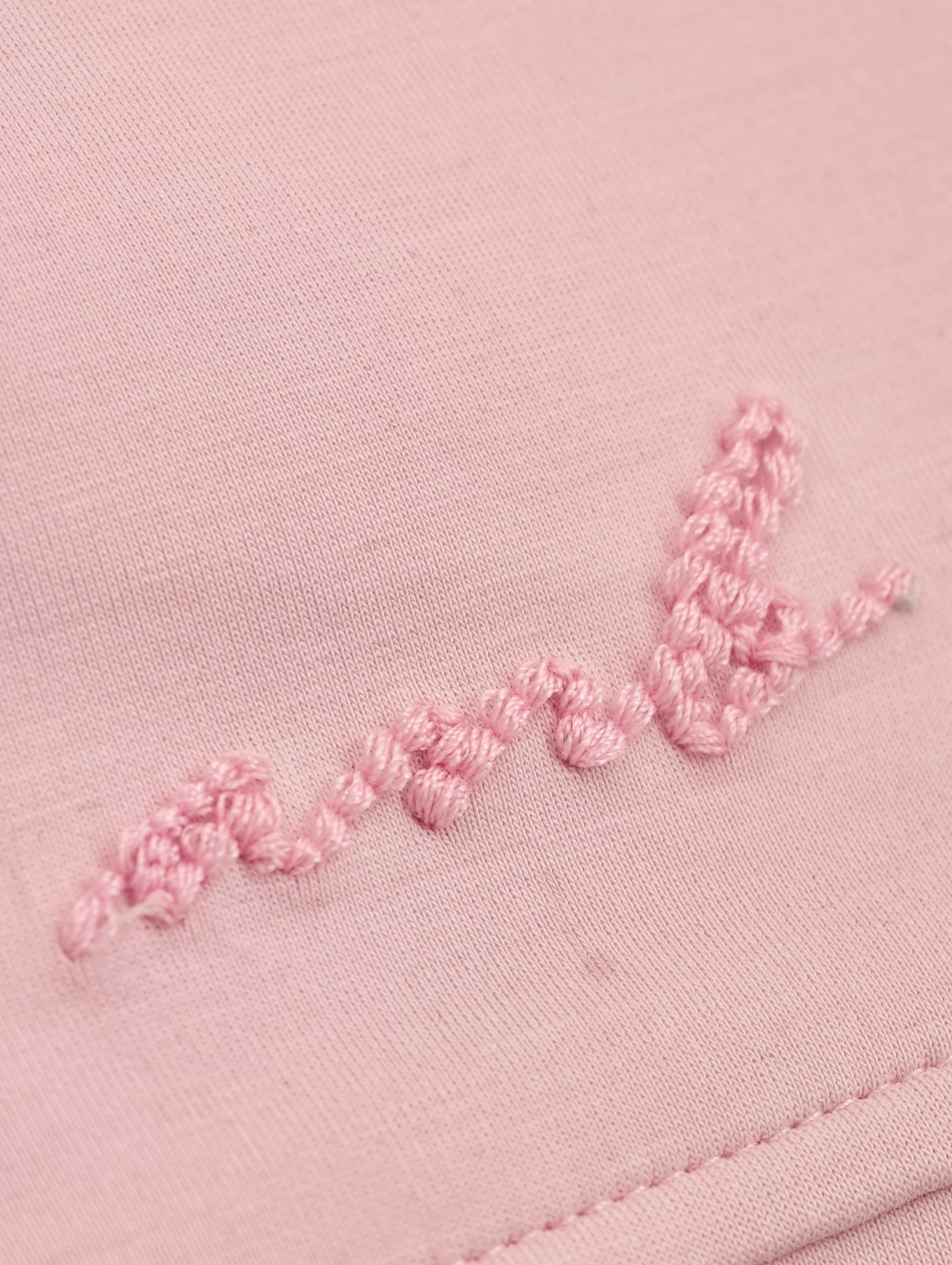 Tonal embroidered script detail near shorts hem