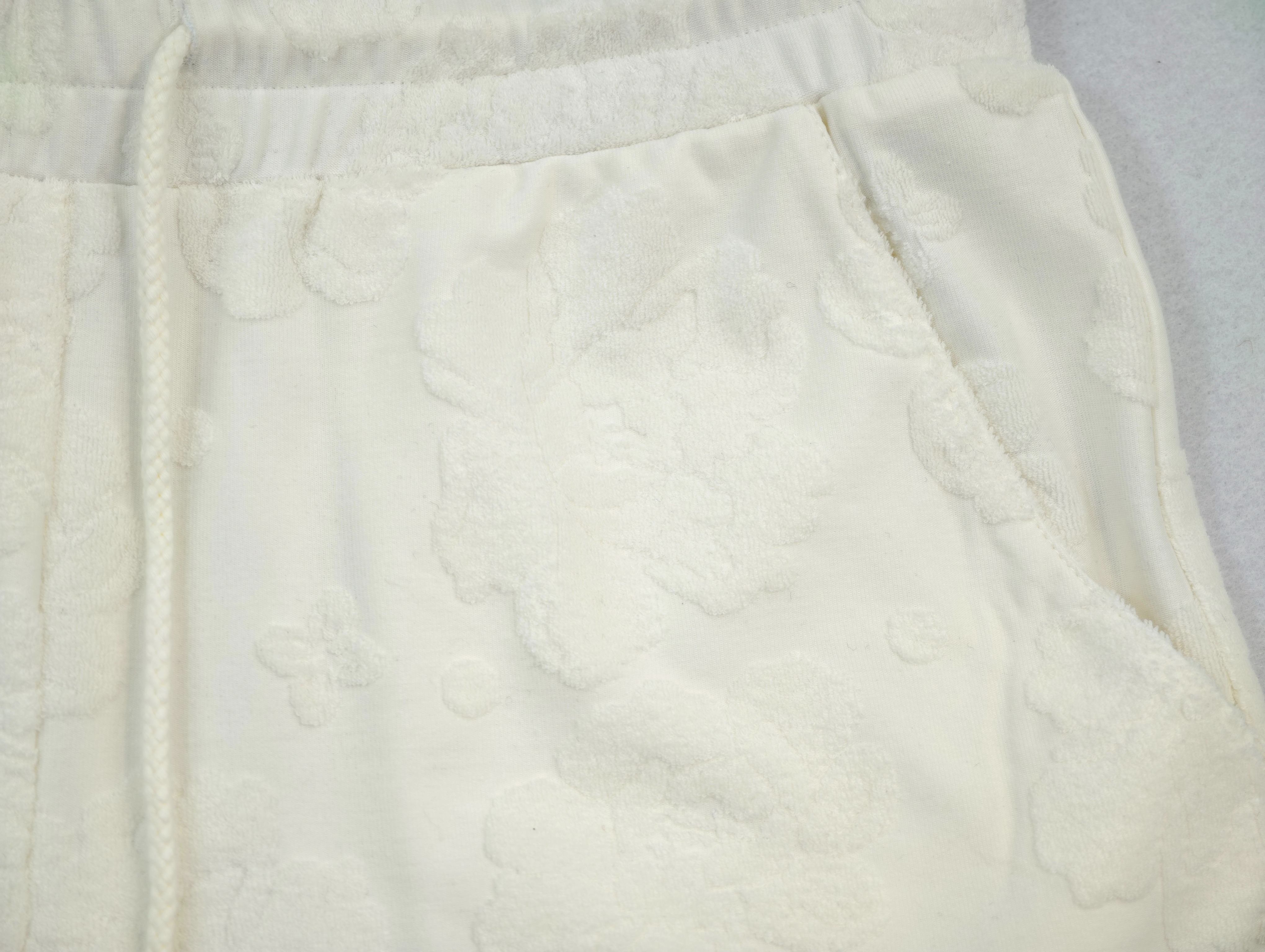 Side pocket detail on raised floral towel-terry fabric