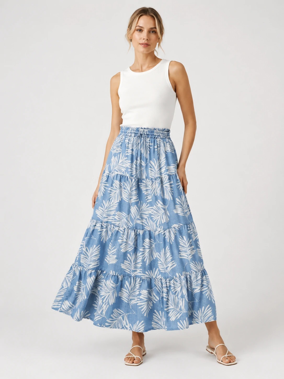 Model wearing blue palm-print tiered TENCEL maxi skirt