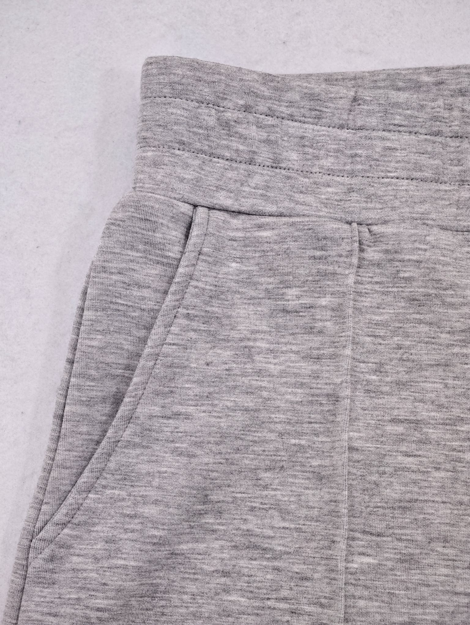 Ribbed waistband and angled pocket on grey shorts