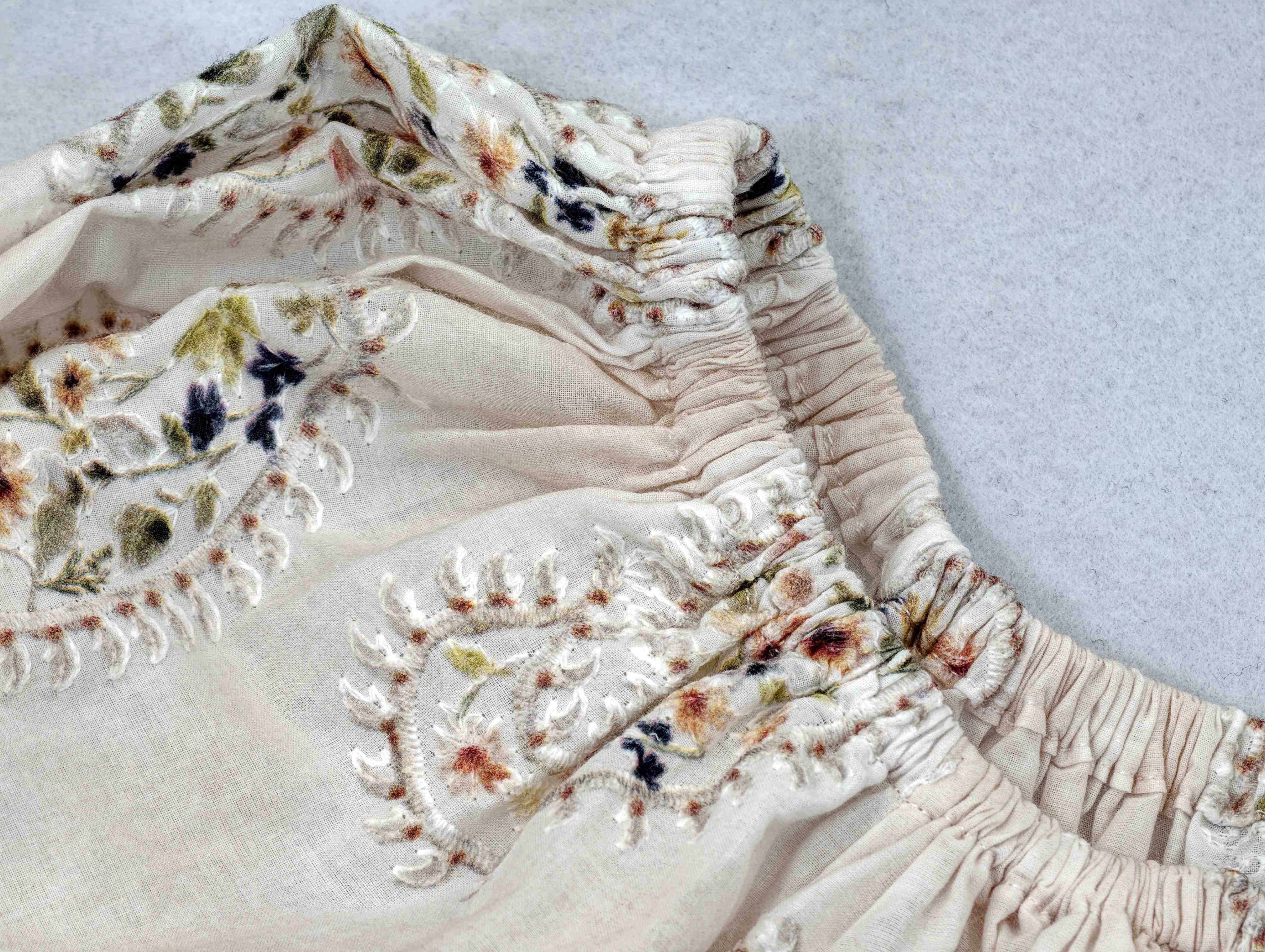 Multicolor embroidered paisley detail on lightweight cotton fabric