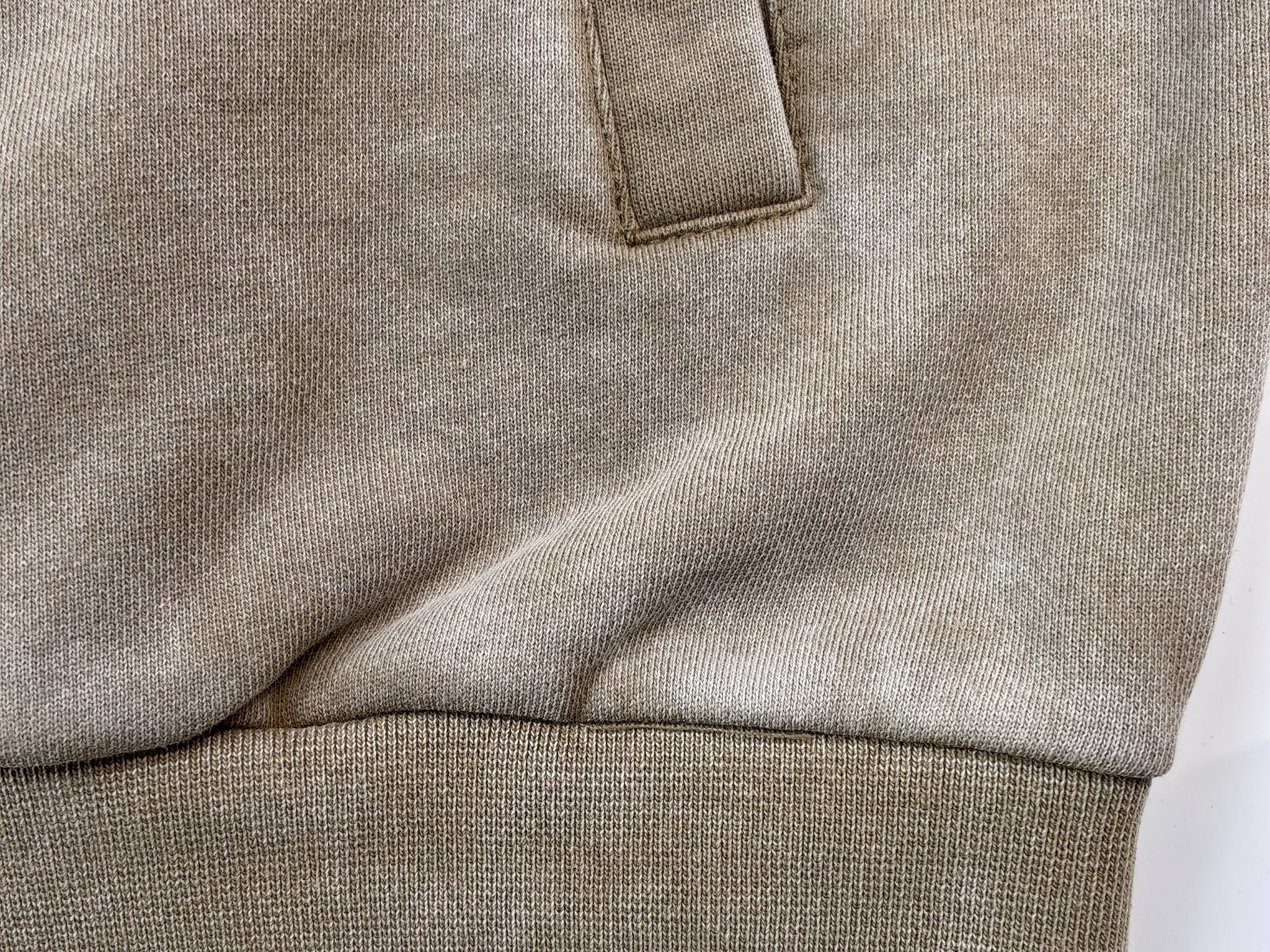 Close-up of welt pocket and ribbed hem construction