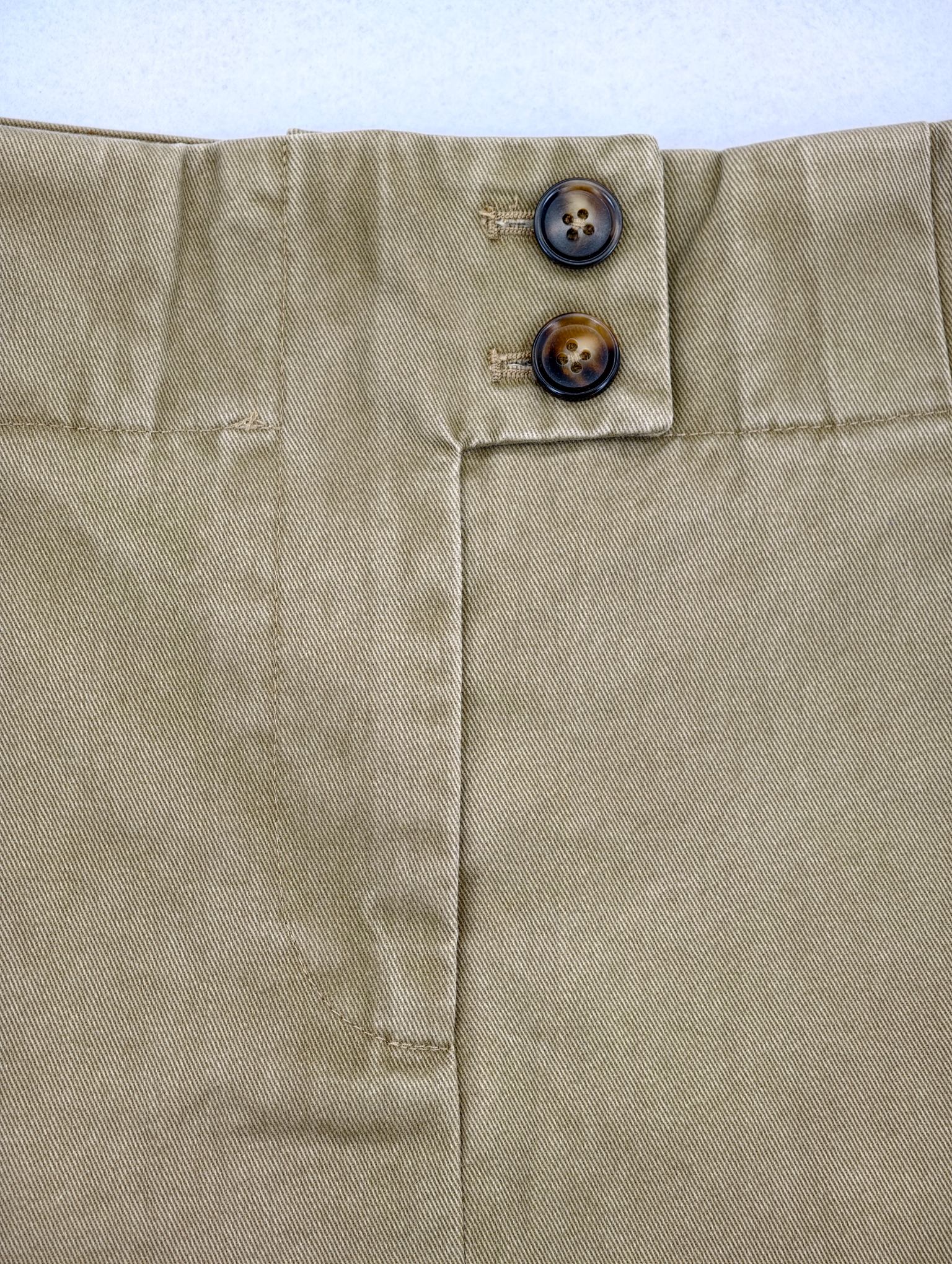 Double-button waistband and concealed front closure close-up