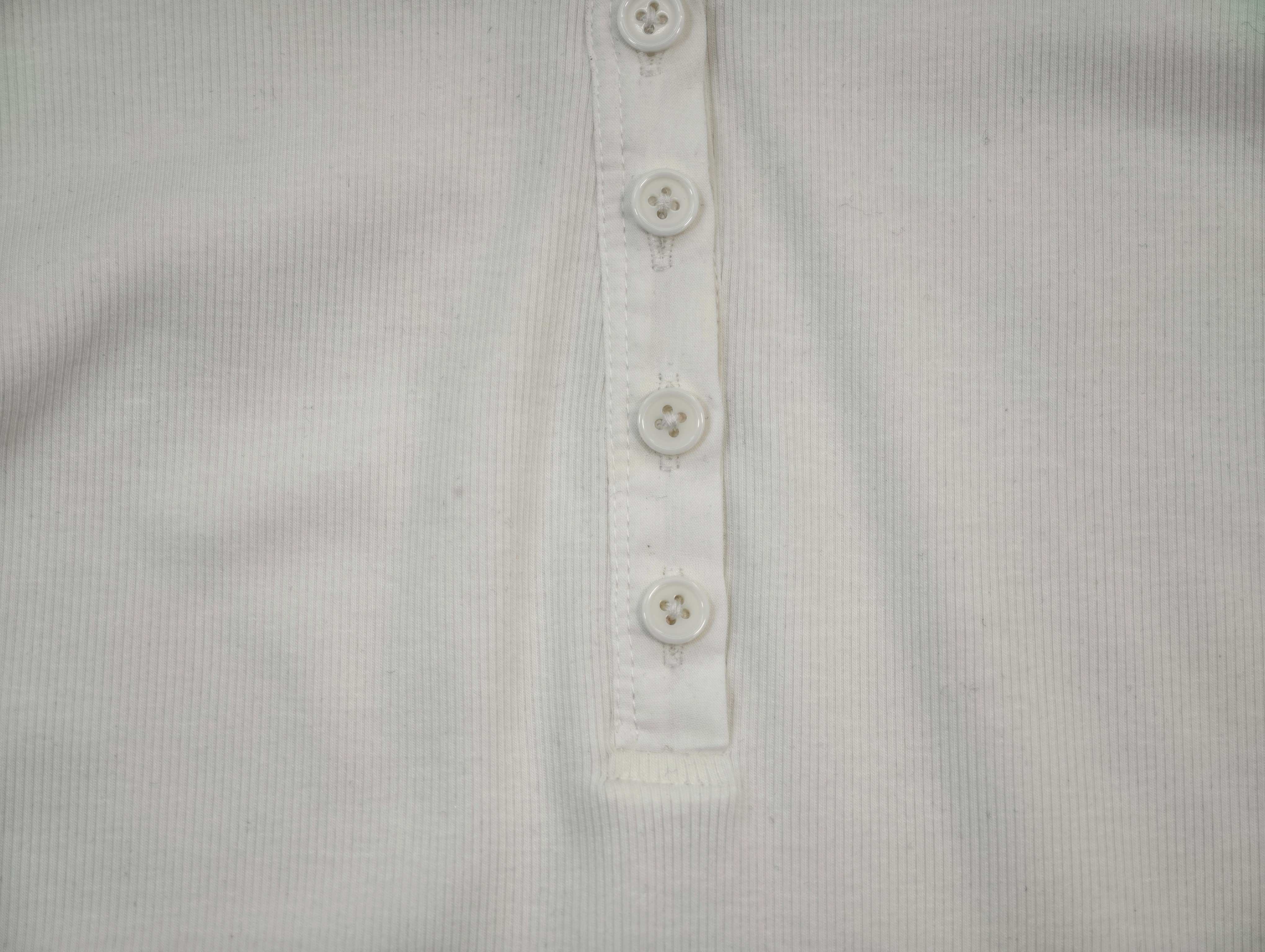 Six-button Henley placket and rib texture close-up