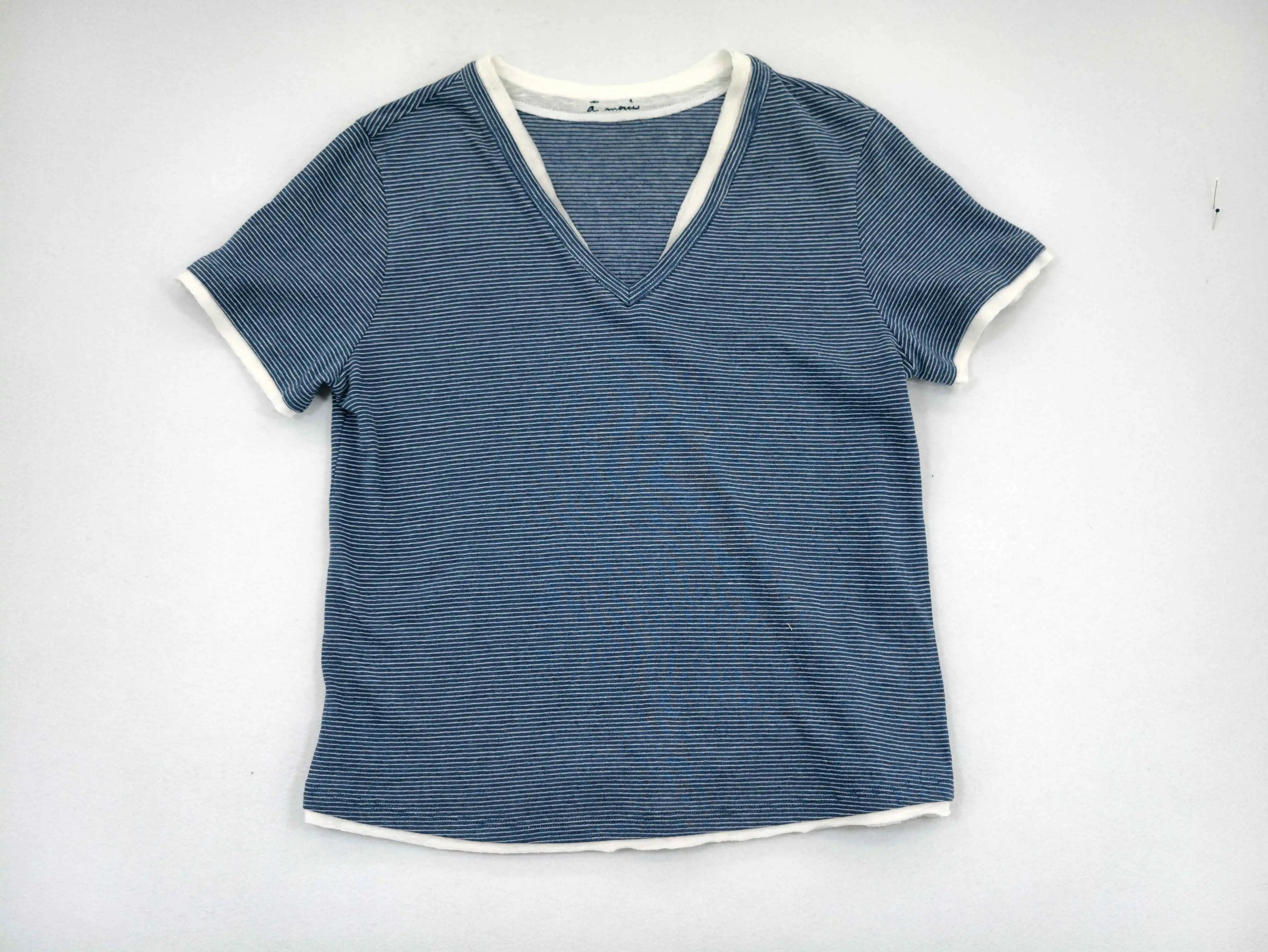 Layered striped T-shirt laid flat from front