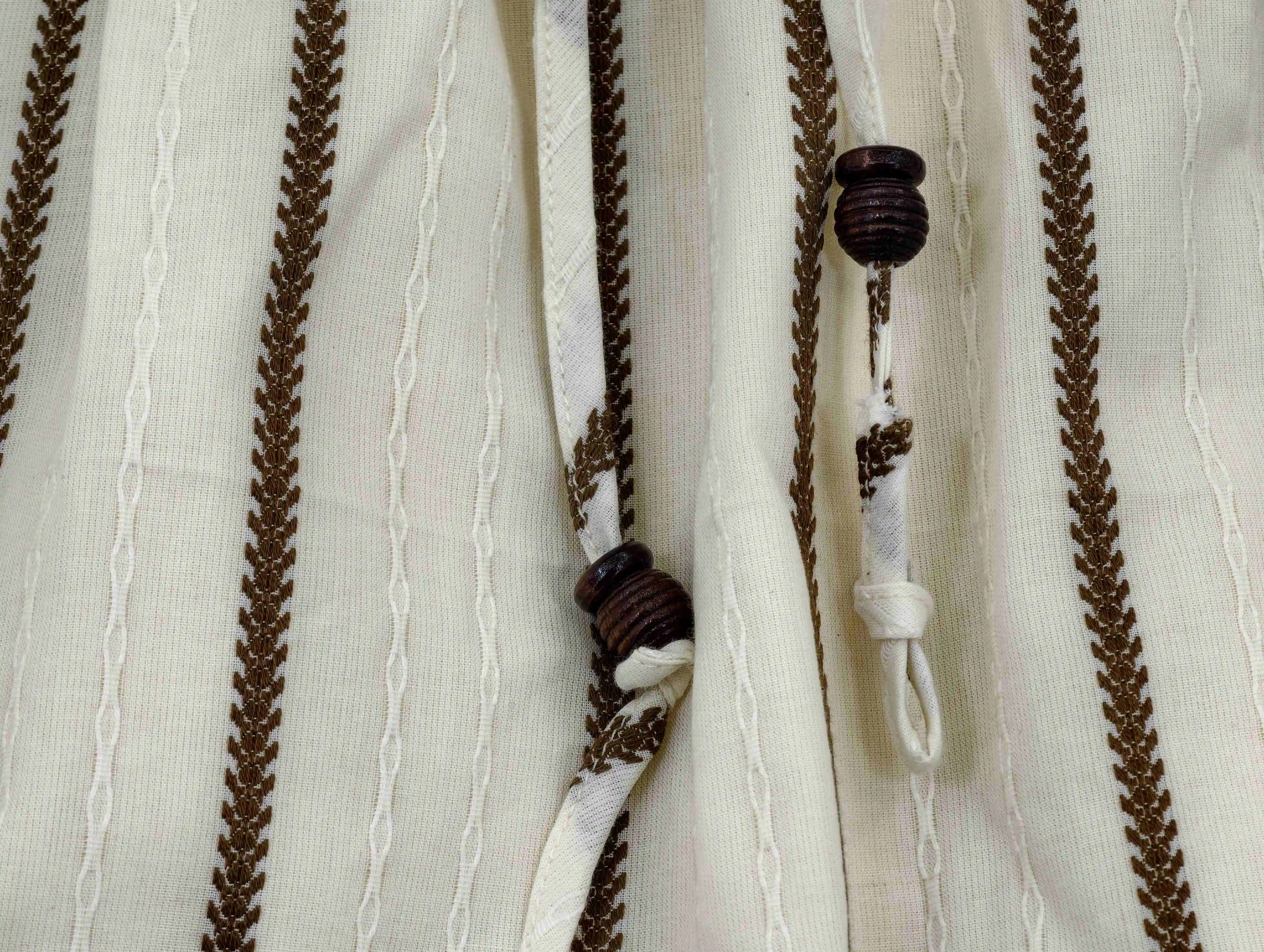 Decorative wooden beads and braided drawcord detail