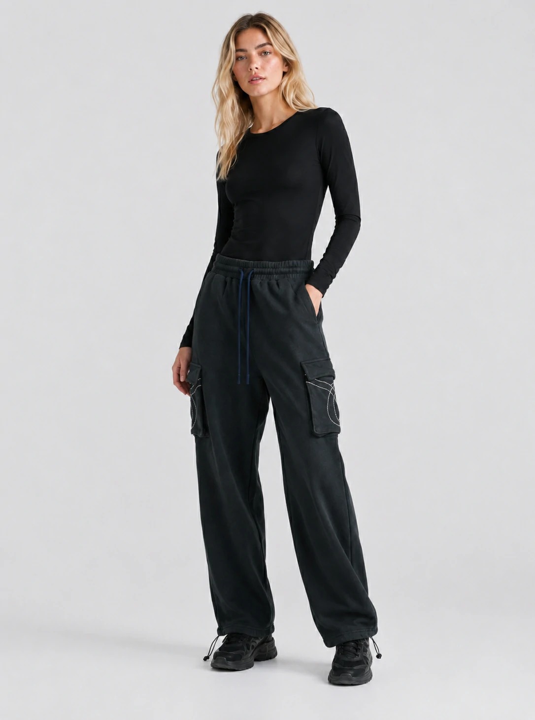 Model wearing washed black wide-leg cargo pants