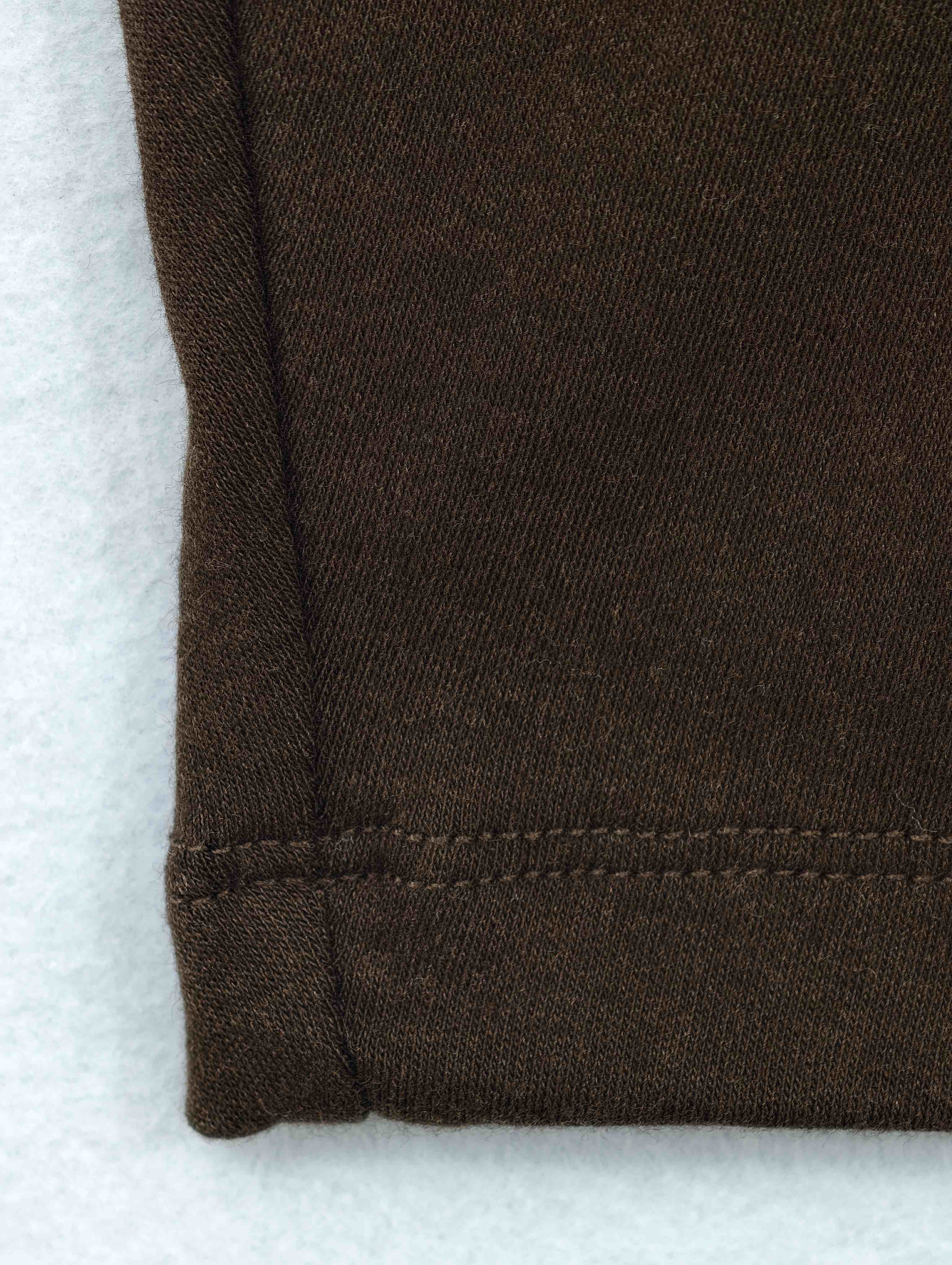 Clean double-needle hem on soft wool-blend jersey