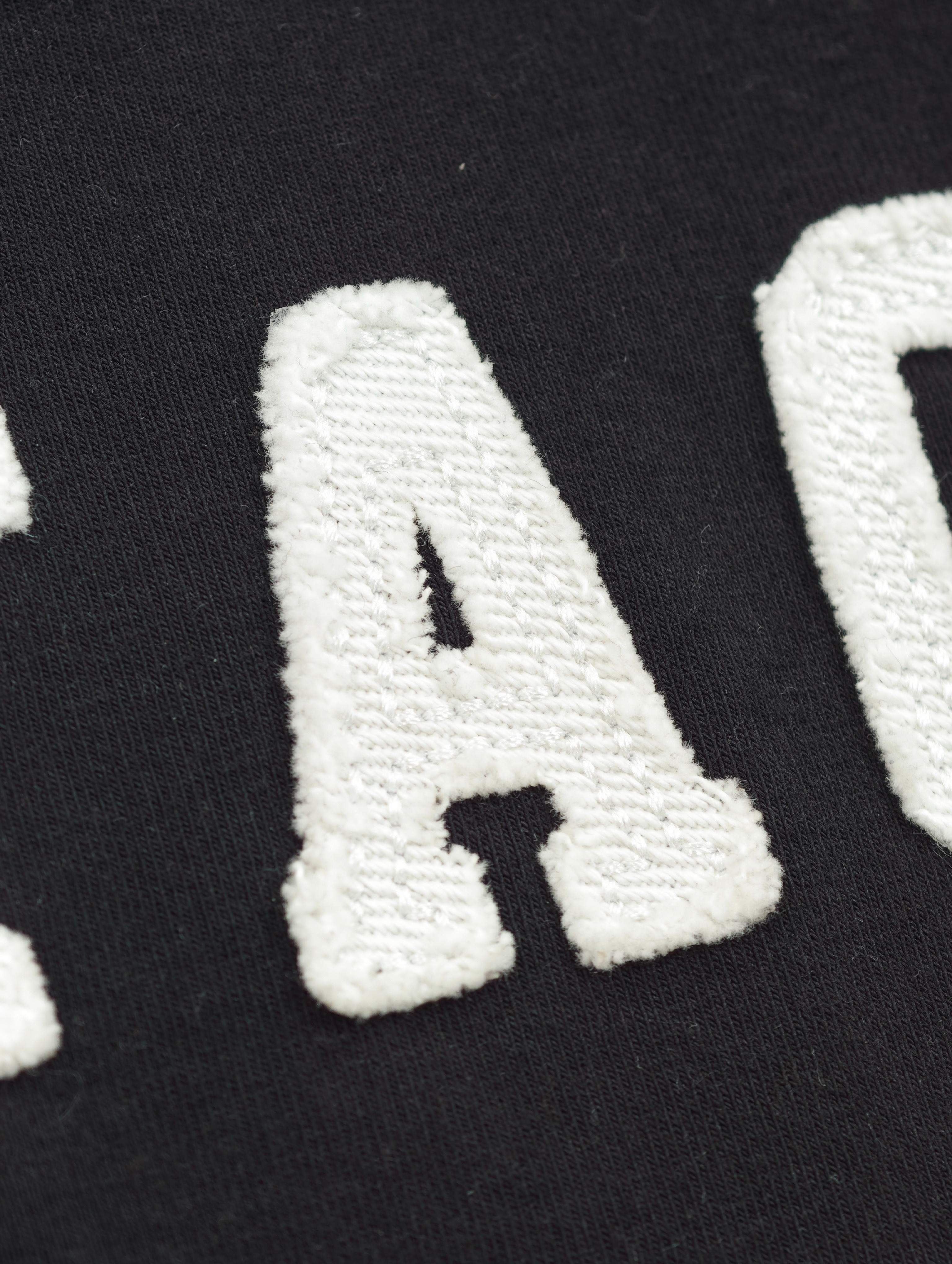 Raised white letter appliqué on black cotton jersey
