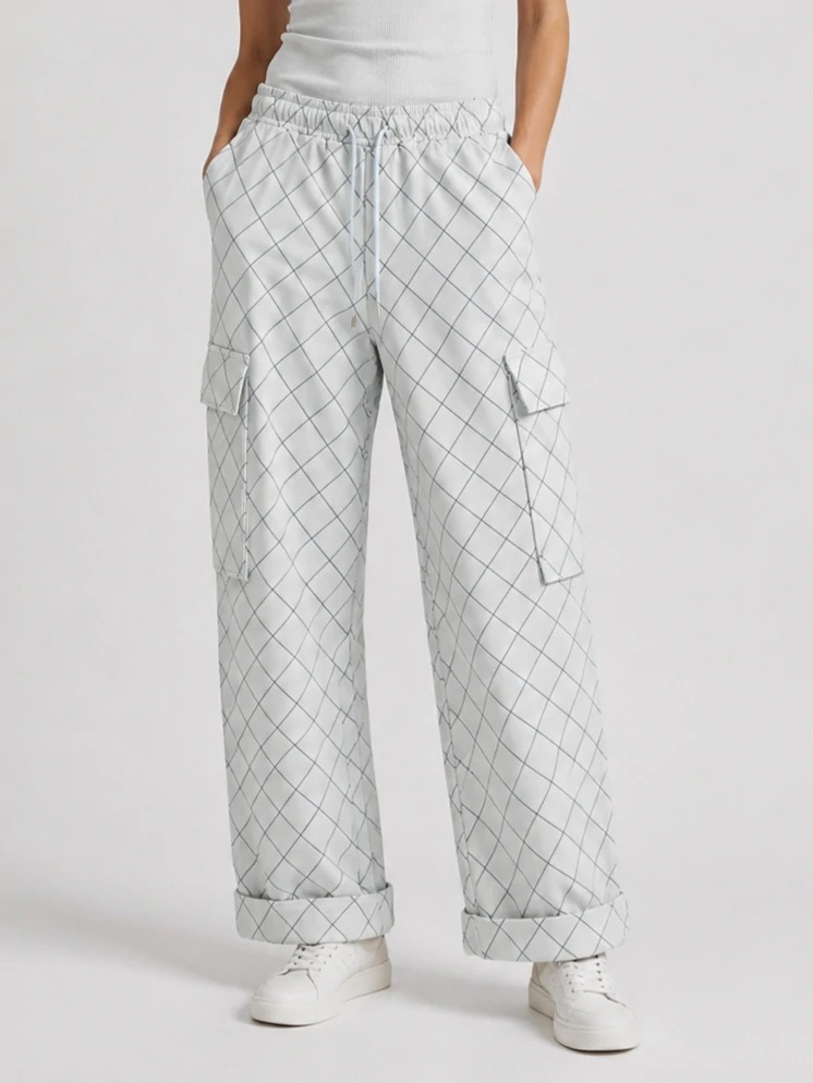 Model wearing light grey grid-print wide-leg cargo pants