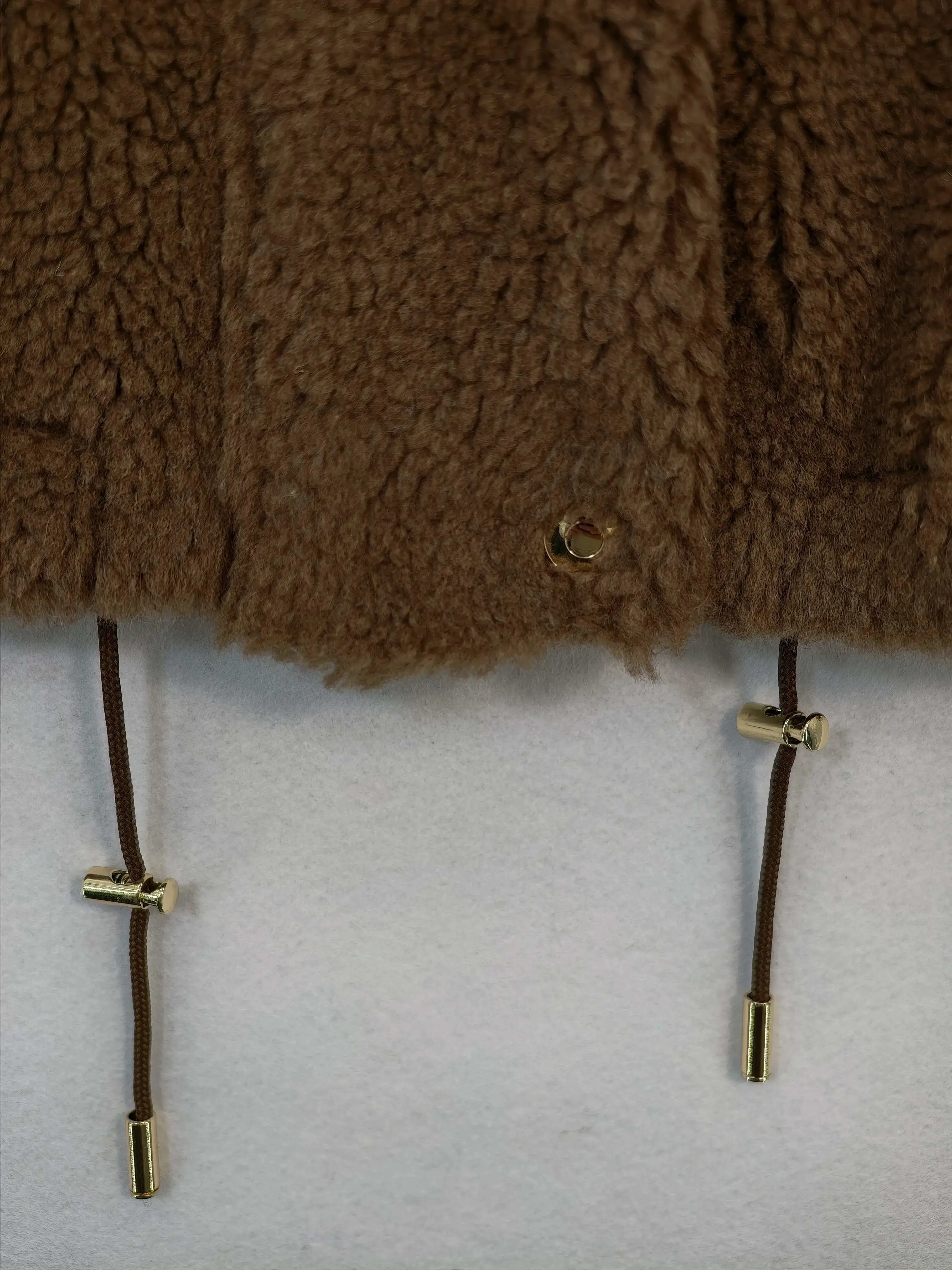 Adjustable drawcord hem with custom metal hardware