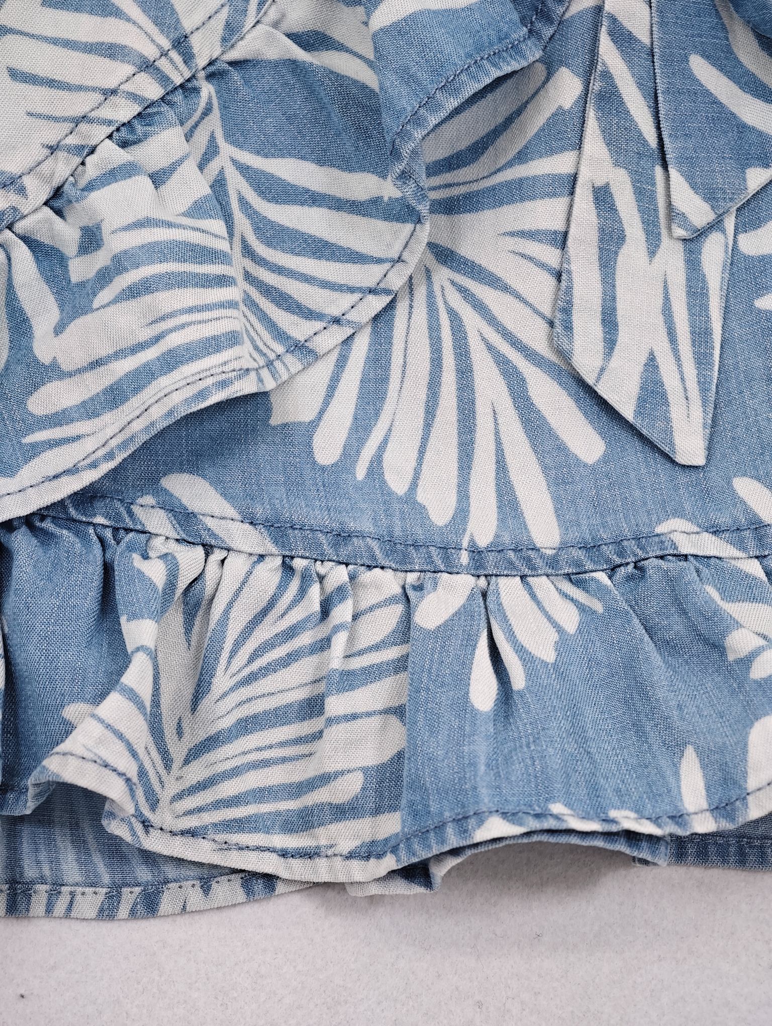 Layered ruffle hem and overlapping skirt panel close-up
