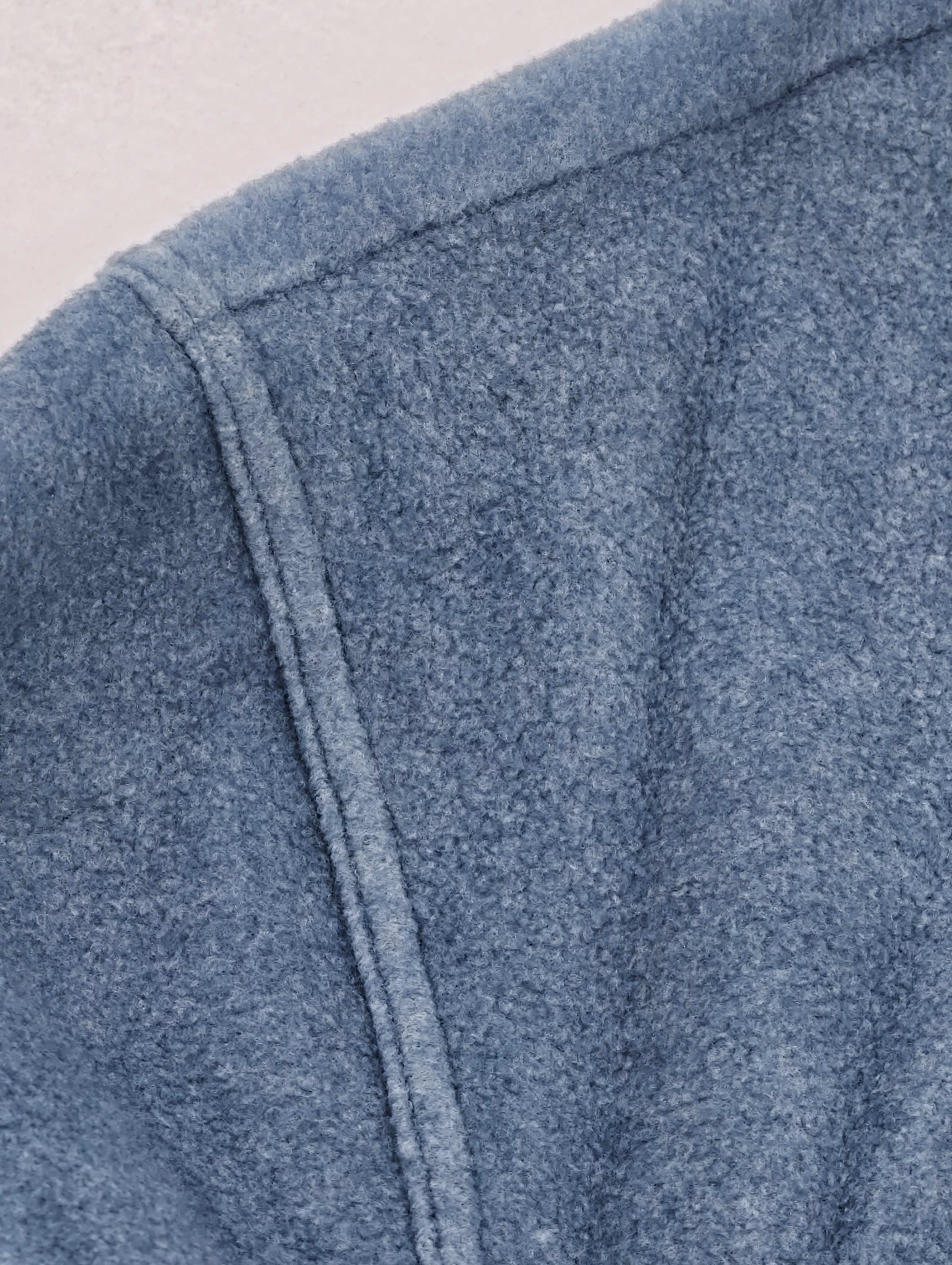 Dropped shoulder seam on soft blue fleece fabric