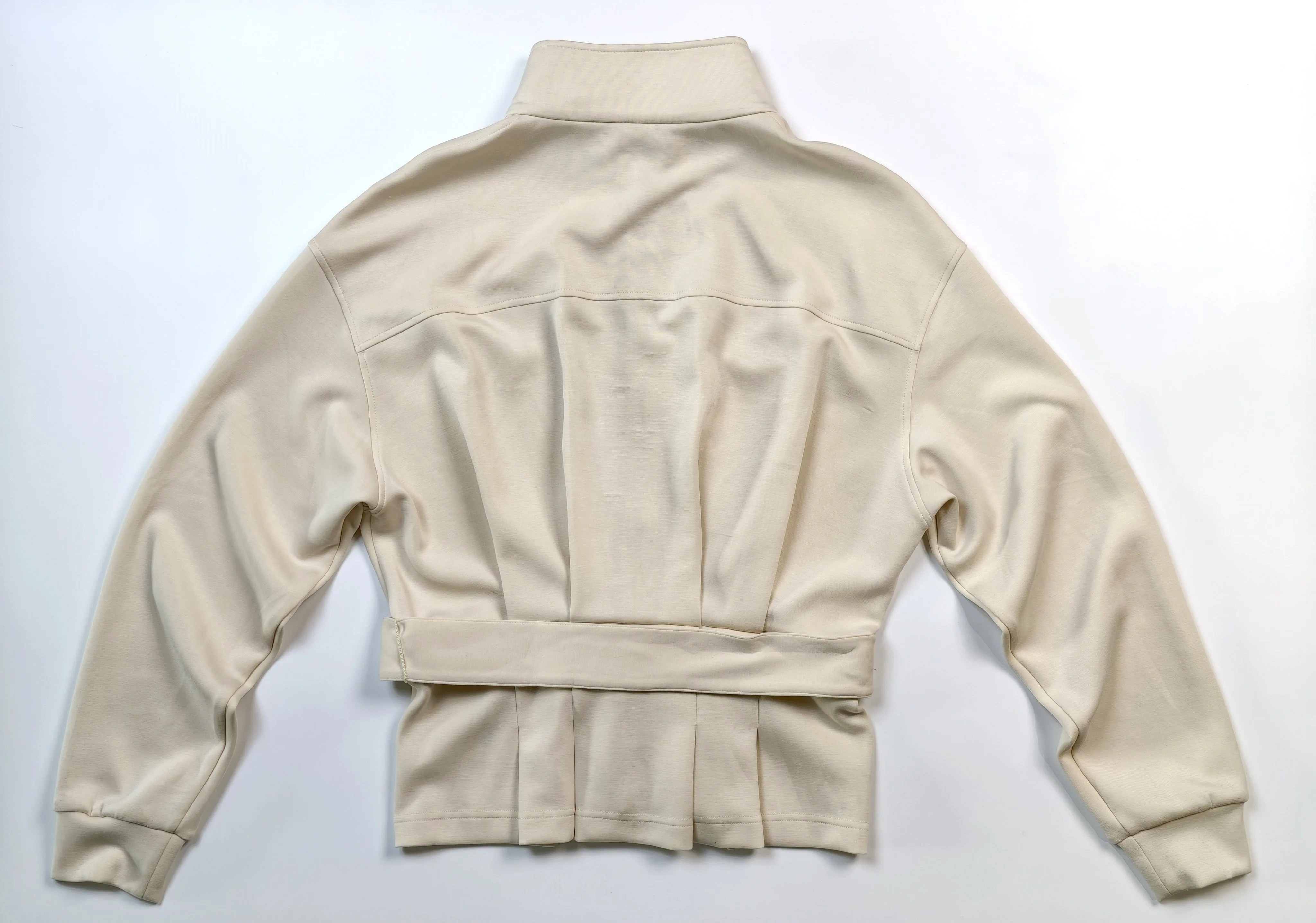 Rear construction with yoke seam and gathered peplum