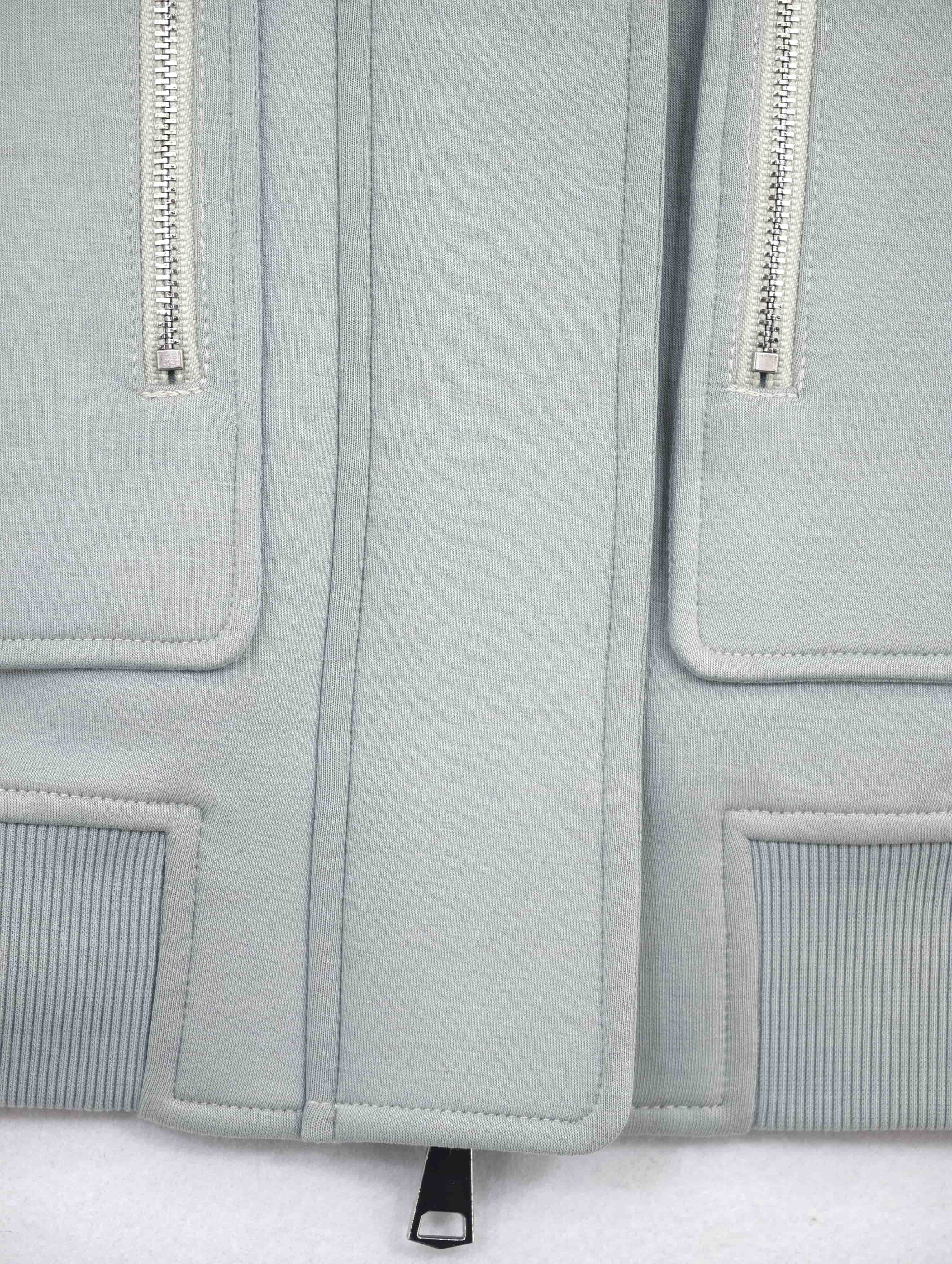 Vertical zip pockets, panel seams and structured hem detail