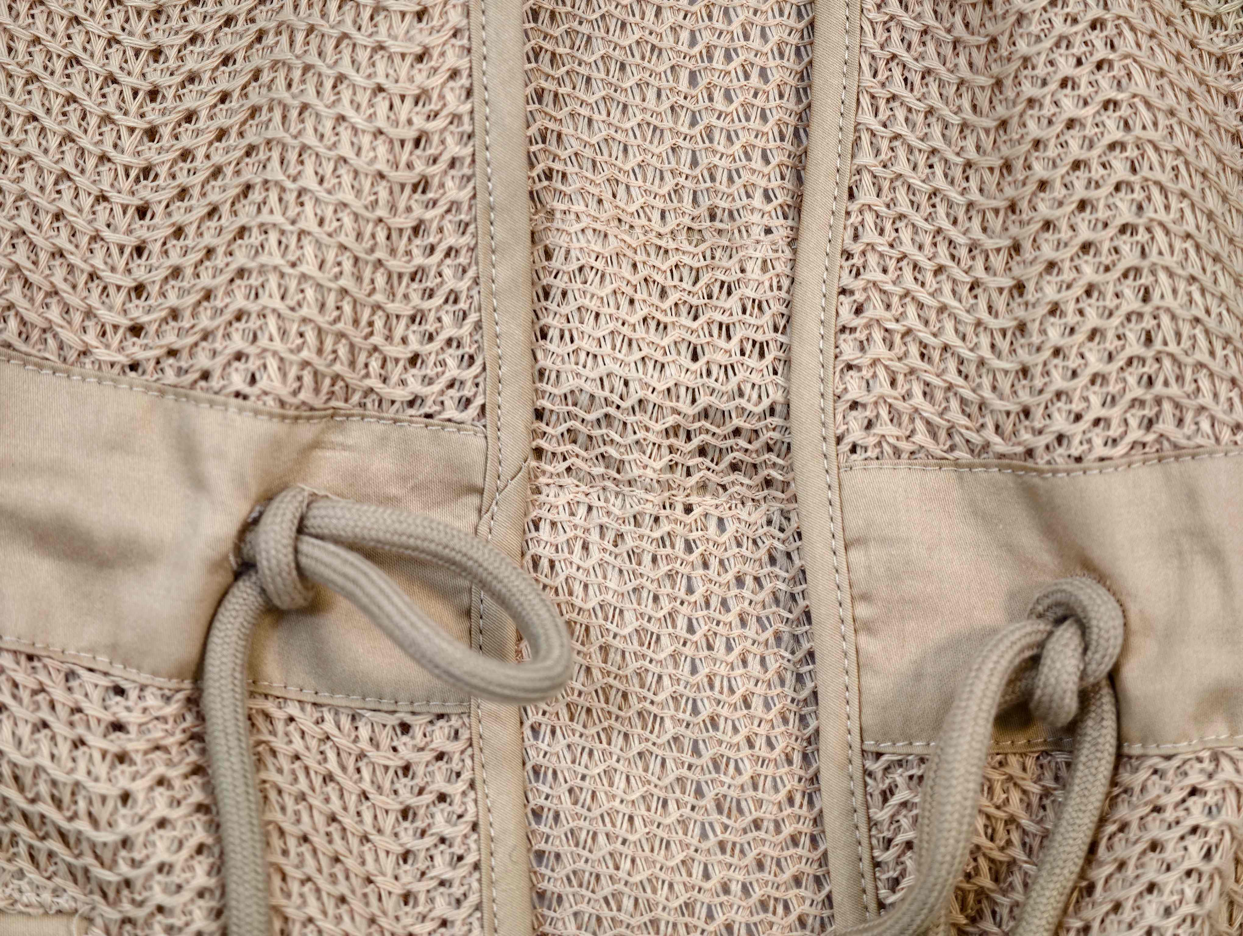 Front binding and adjustable drawcord construction close-up
