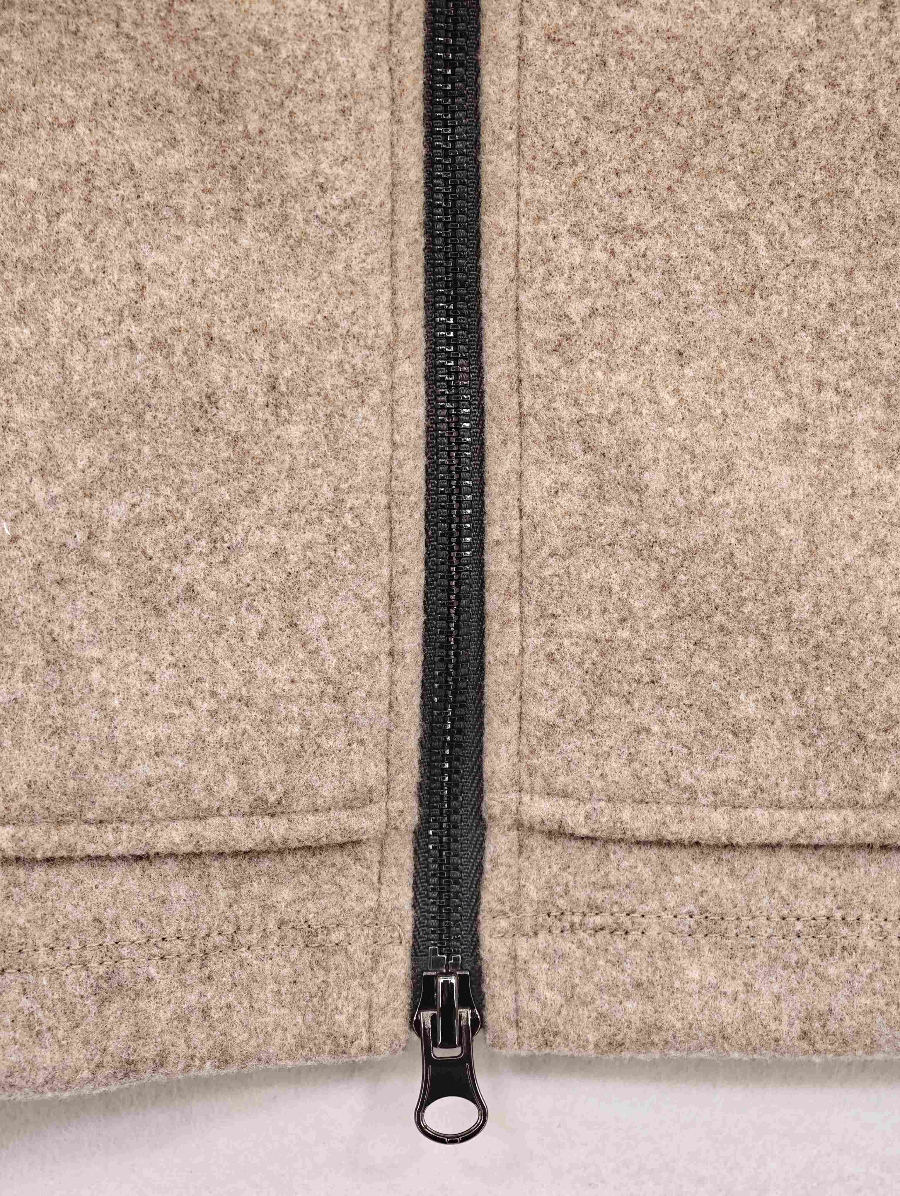 Black front zipper with structured lower hem detail