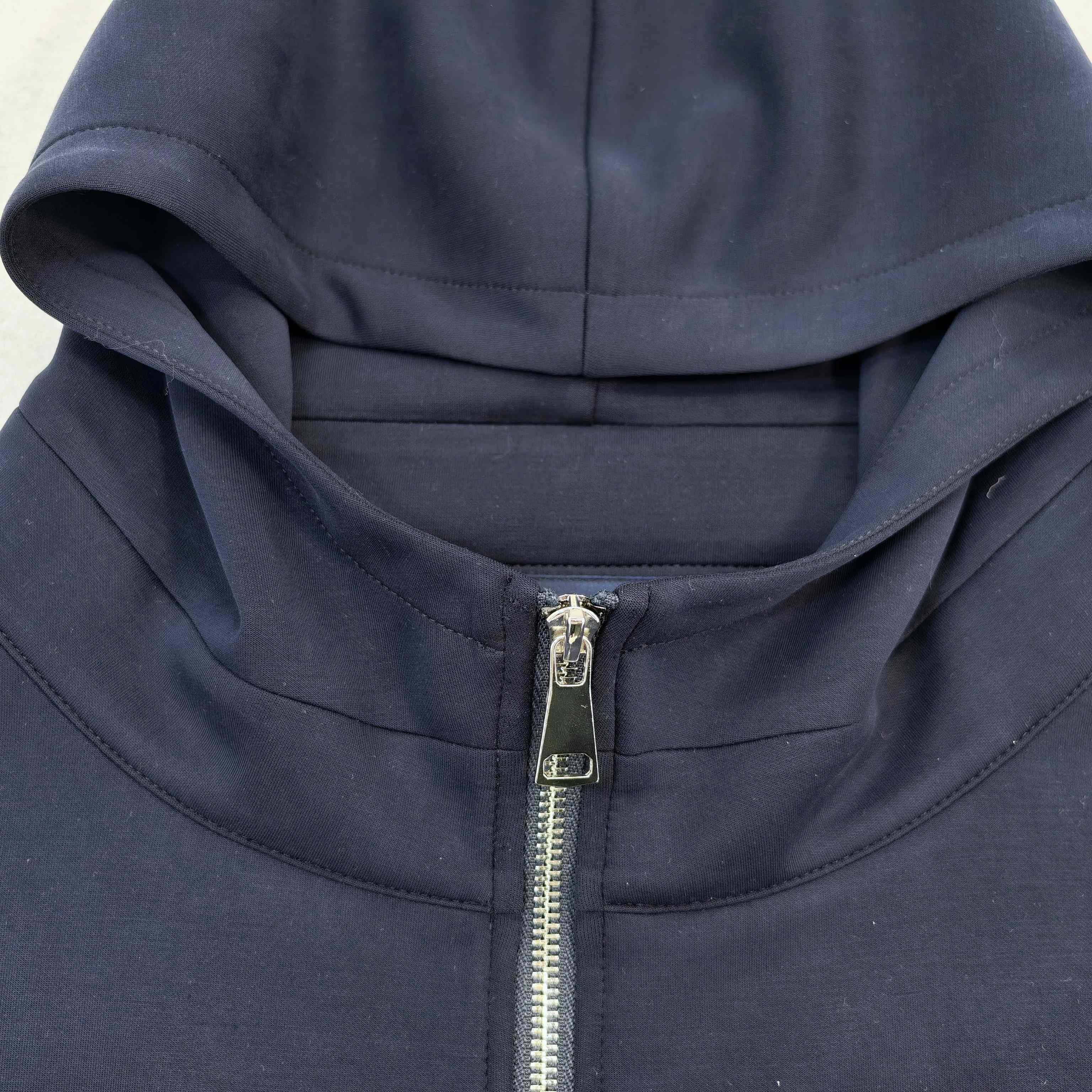 Two-way metal zipper and hood construction close-up