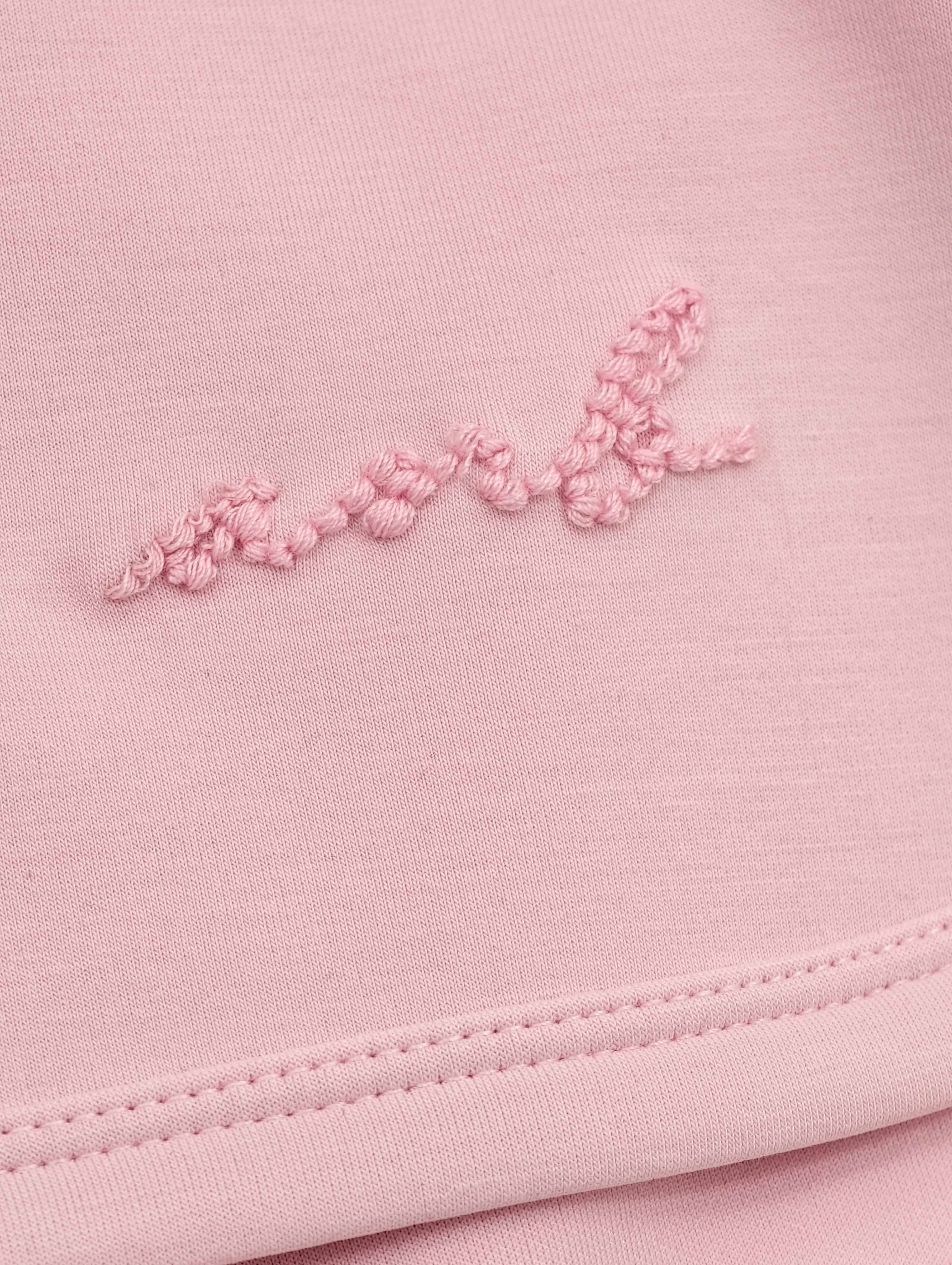 Tonal script embroidery on smooth stretch knit fabric