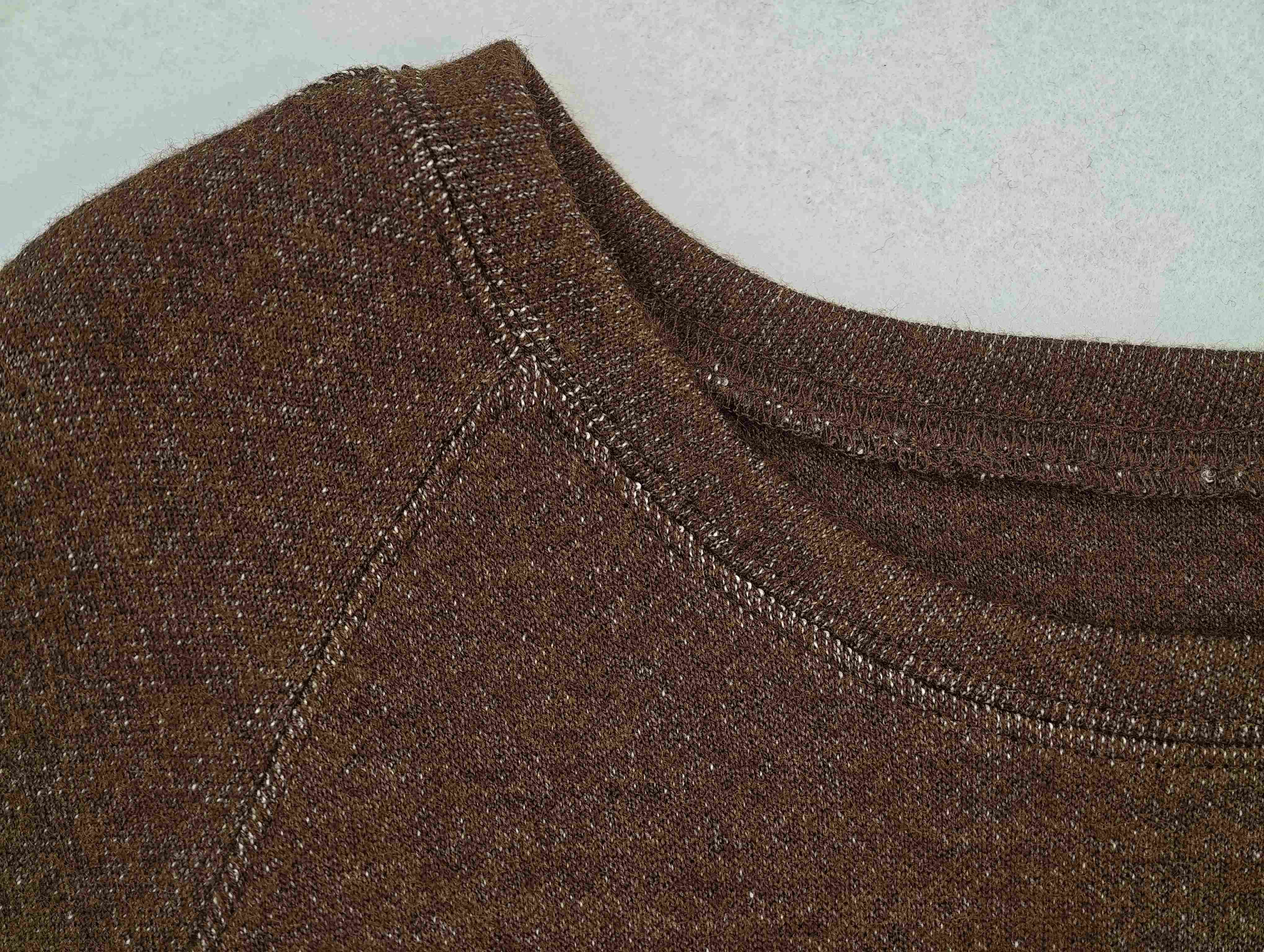 Crew neckline and curved raglan seam close-up