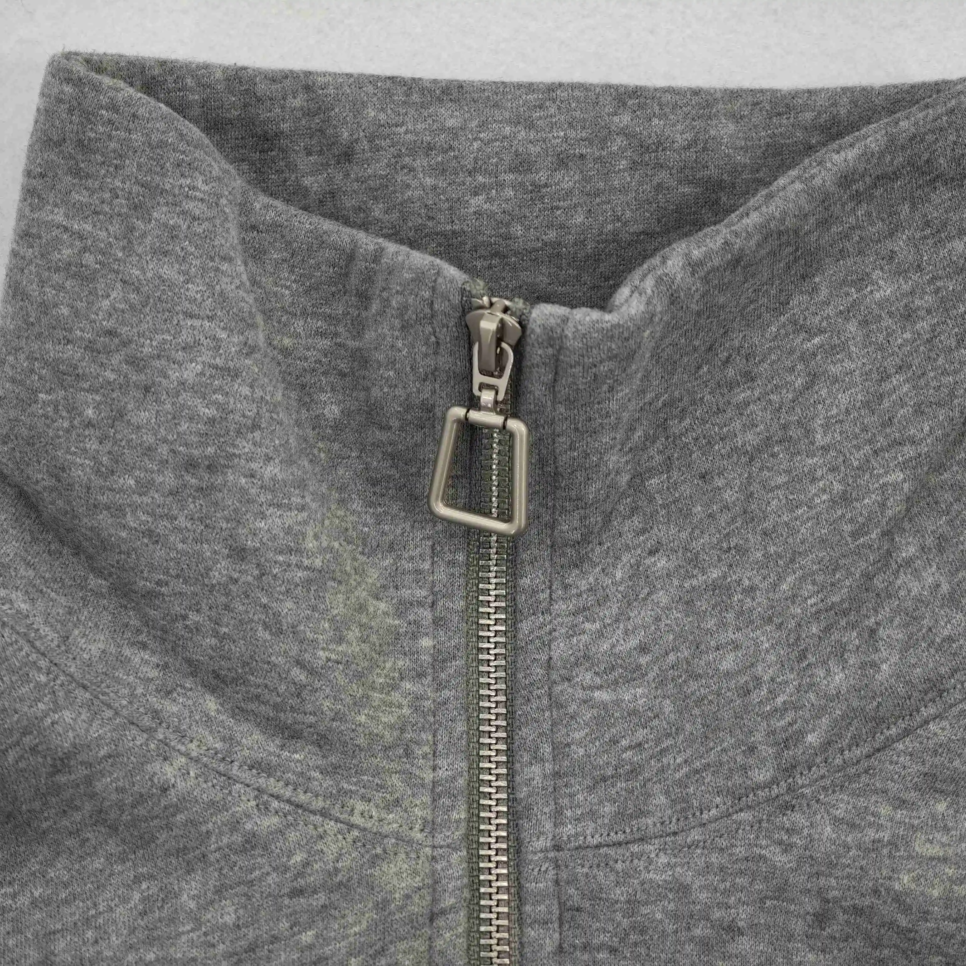Metal zipper pull and raised collar construction close-up