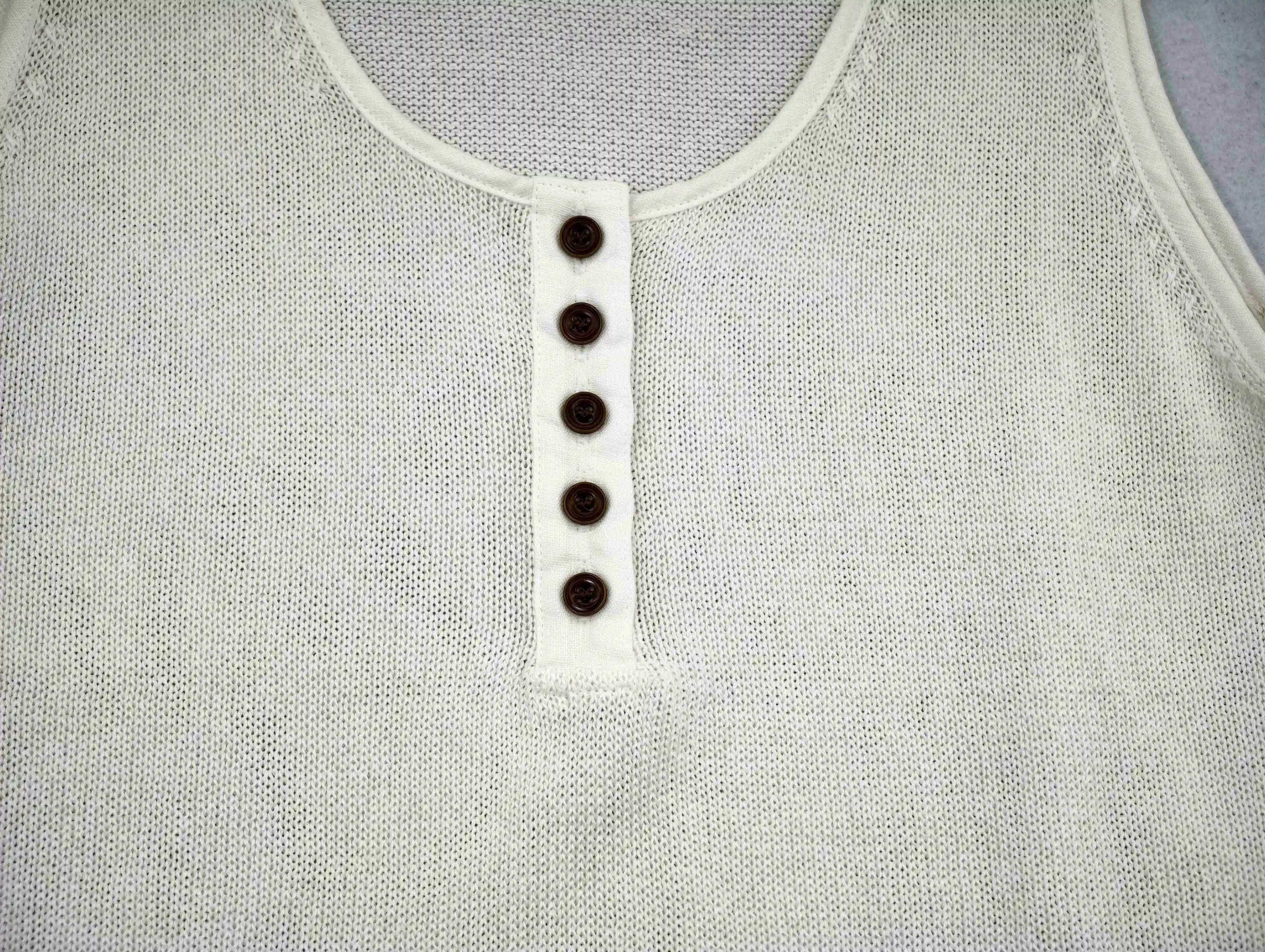 Scoop neckline, linen binding and five-button placket by a knitwear manufacturer