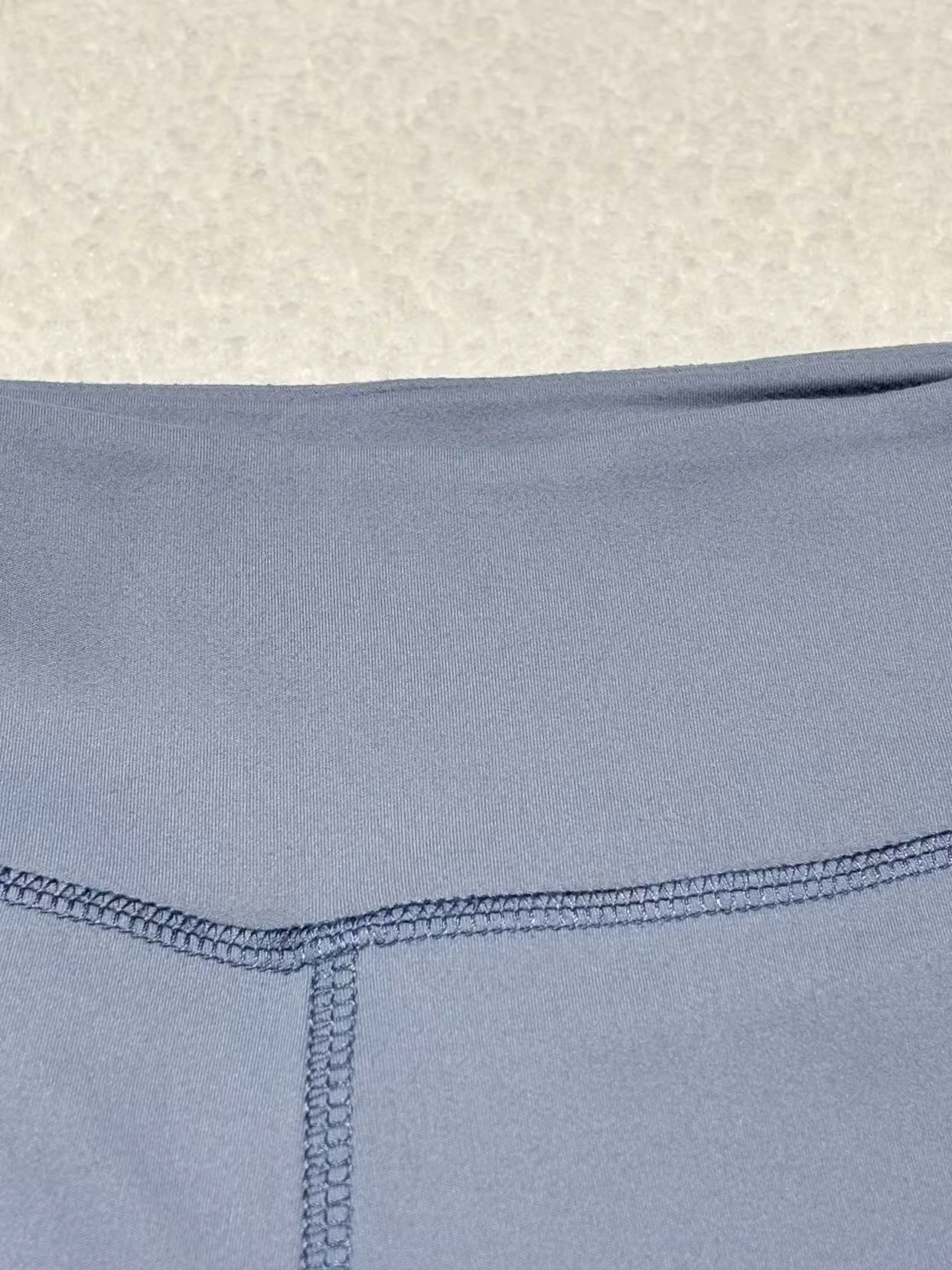 High-rise waistband seam construction on stretch activewear pants