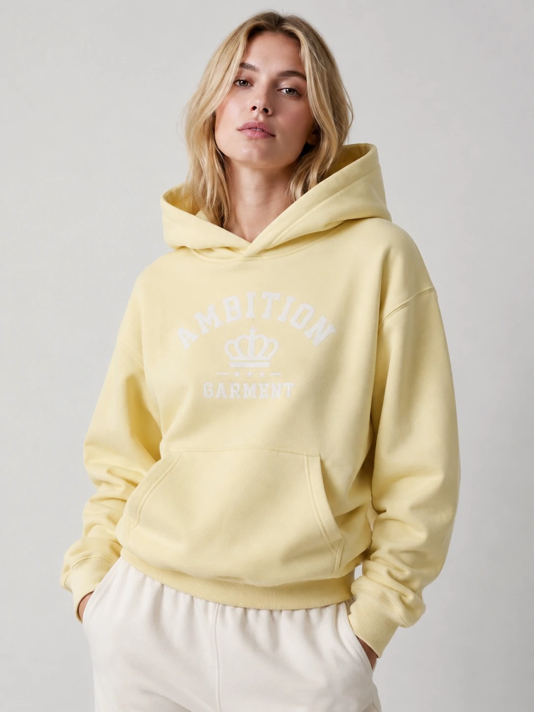 Model wearing butter yellow graphic pullover hoodie