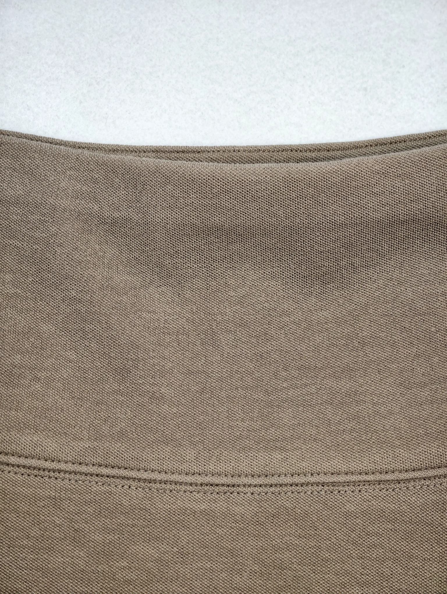 Wide waistband and upper panel seam construction detail