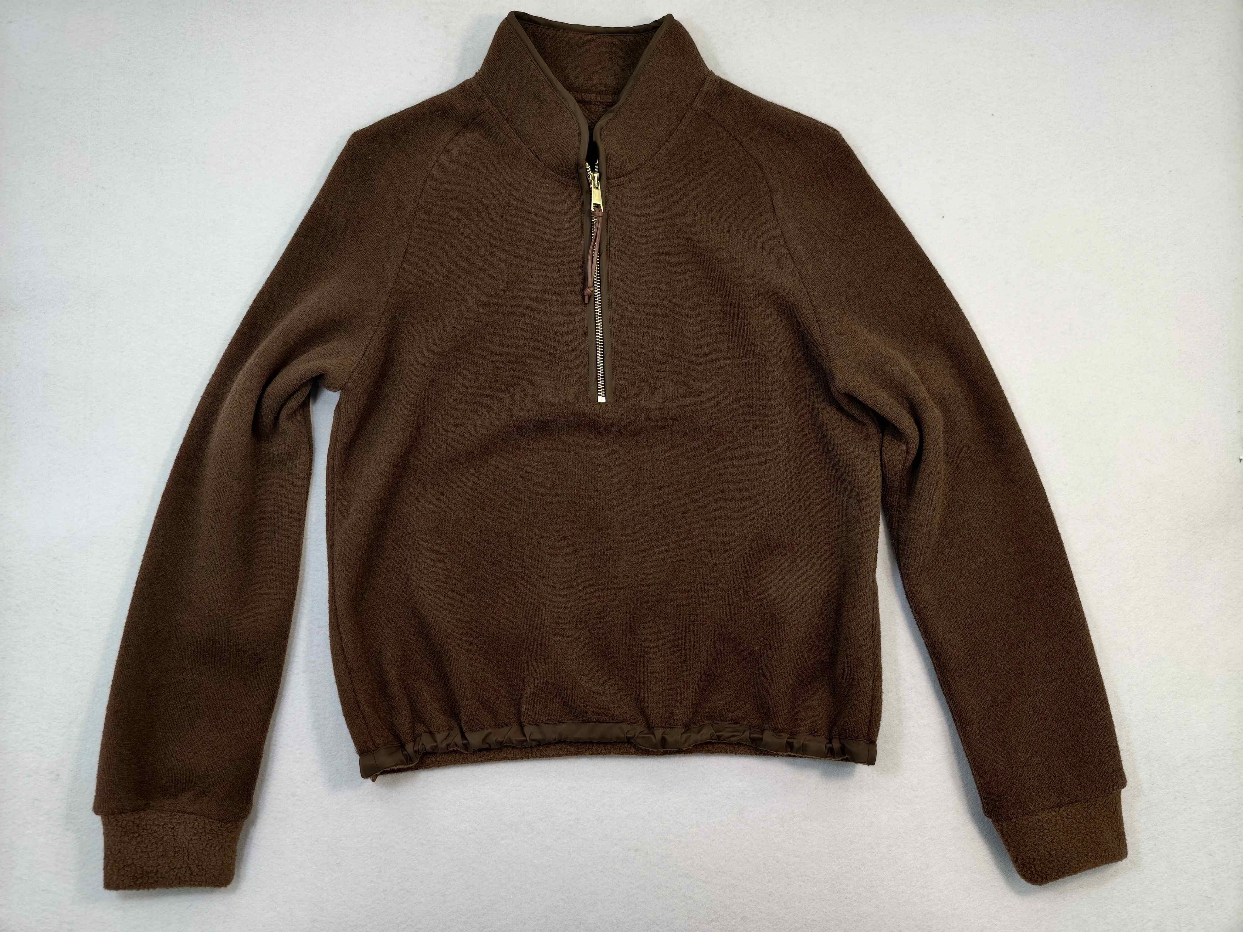Flat front view with raised collar and gathered hem