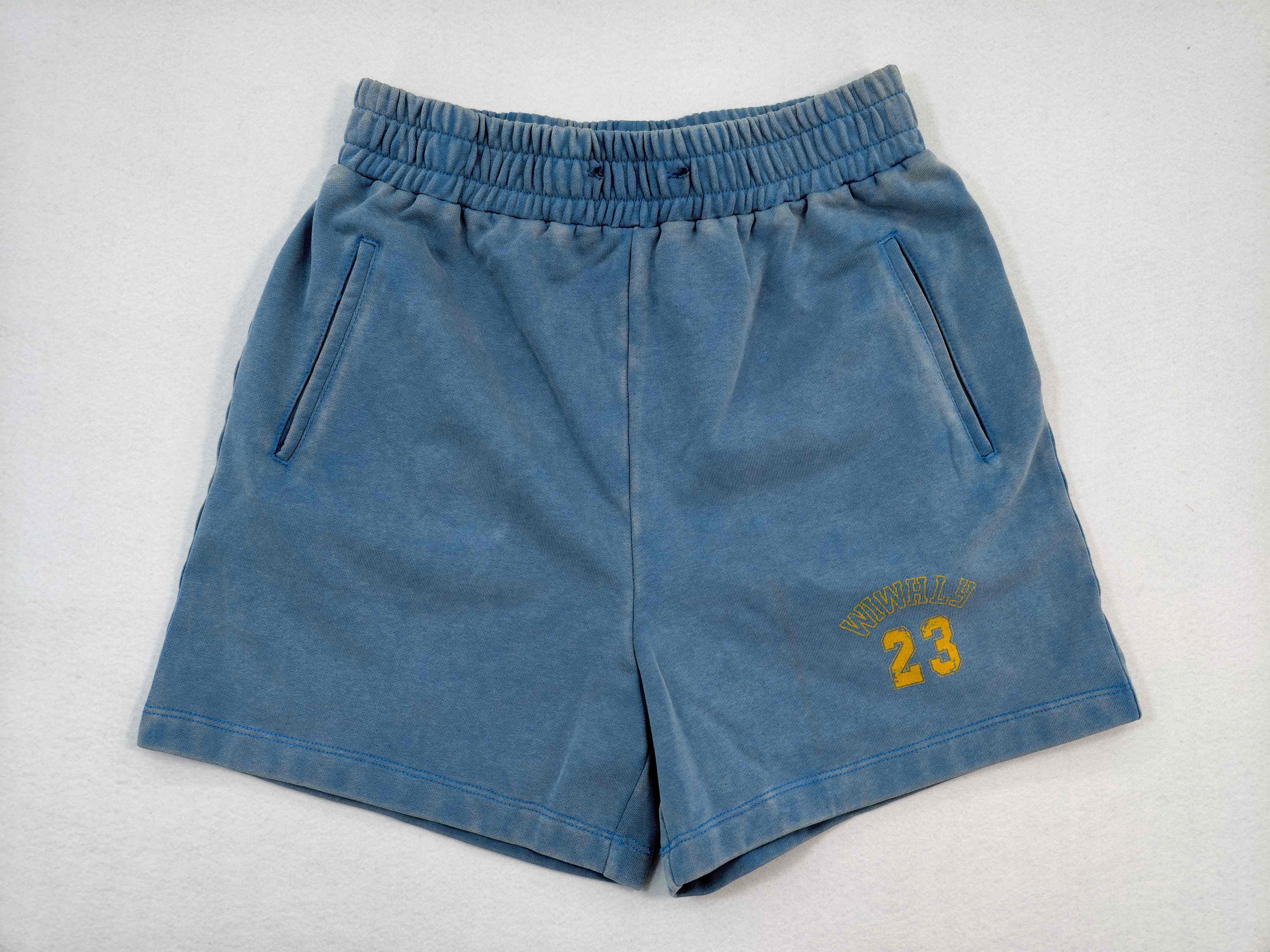 Custom washed sweat shorts with elastic waist and side pockets