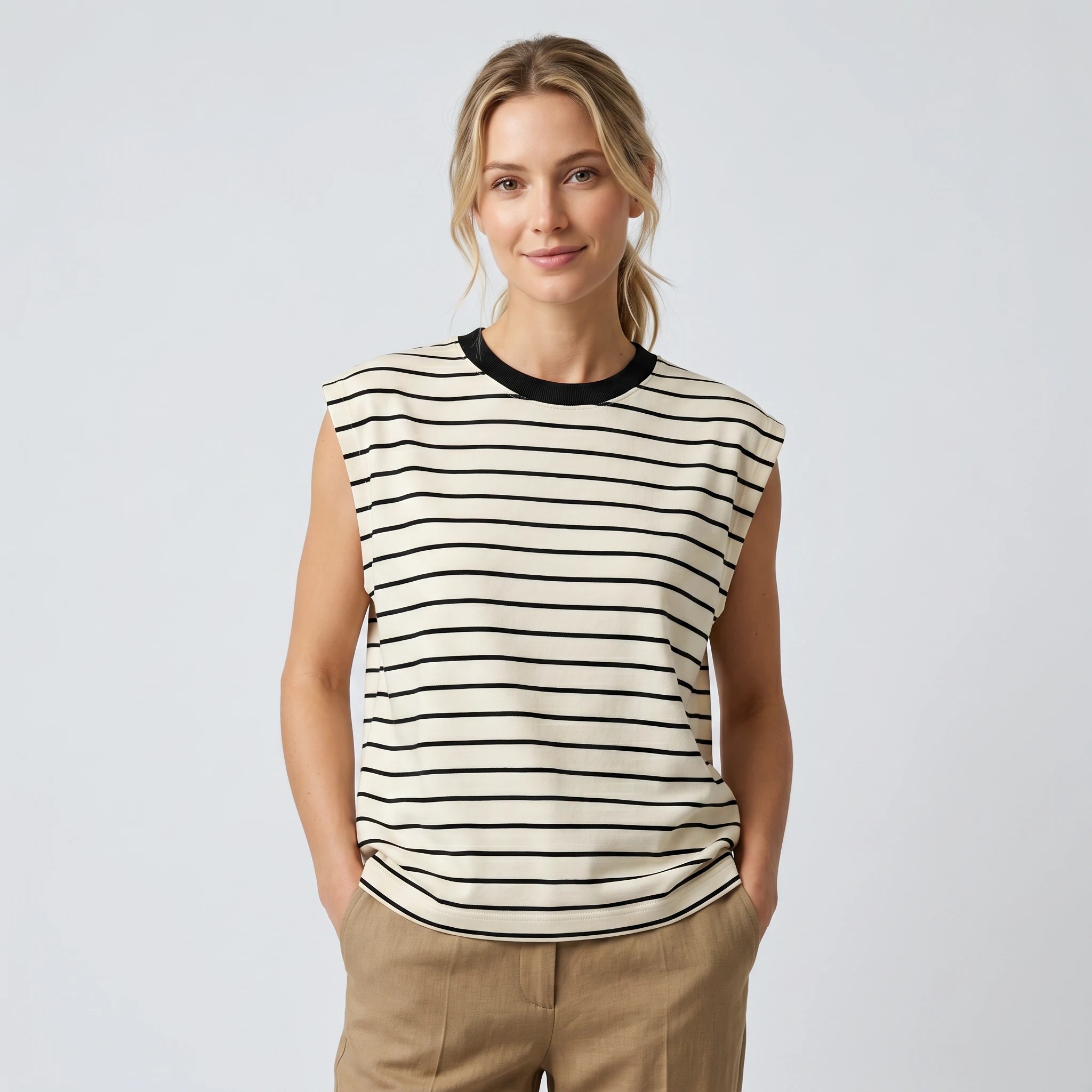 Woman wearing ivory and black striped sleeveless interlock top