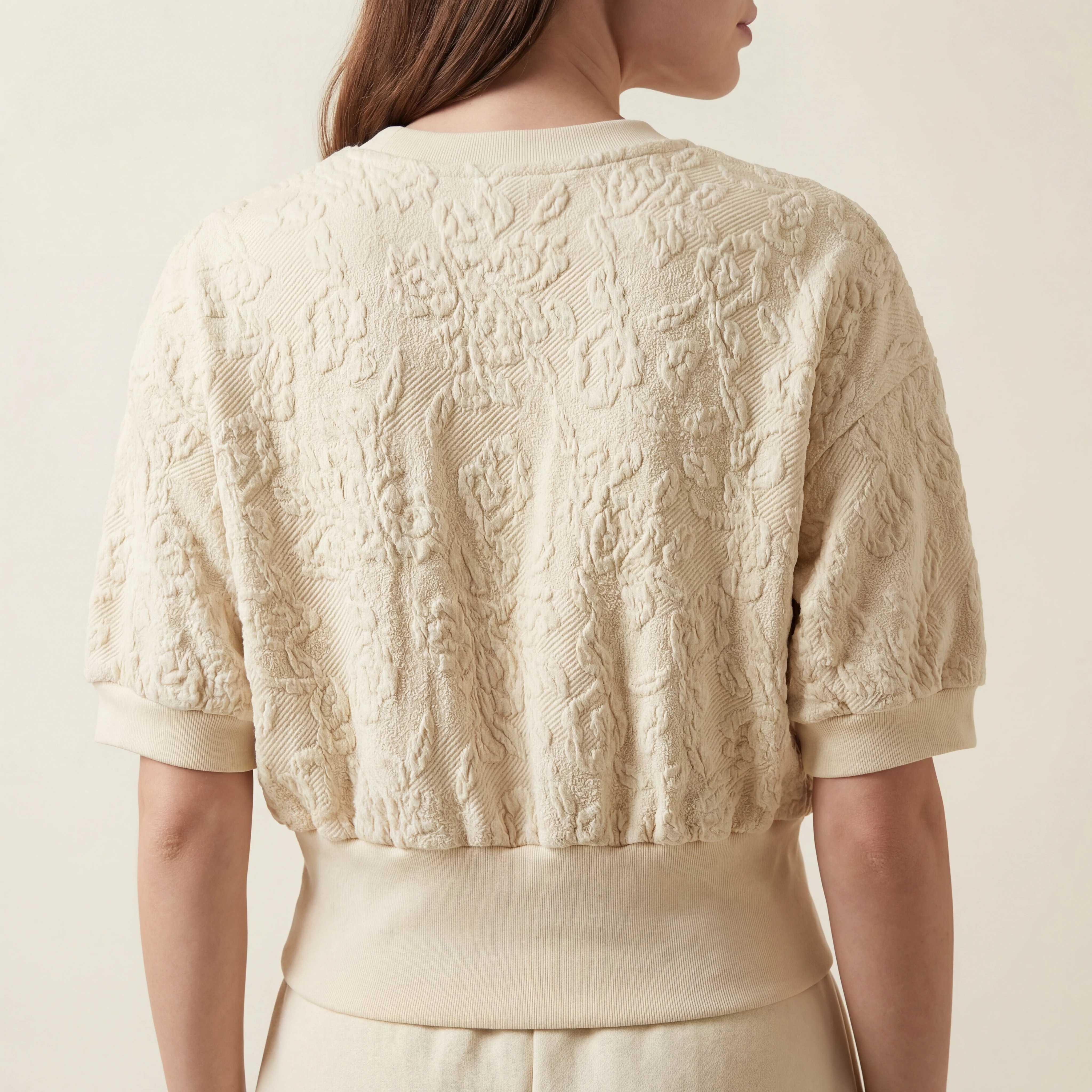 Back view of textured cropped top with wide rib hem