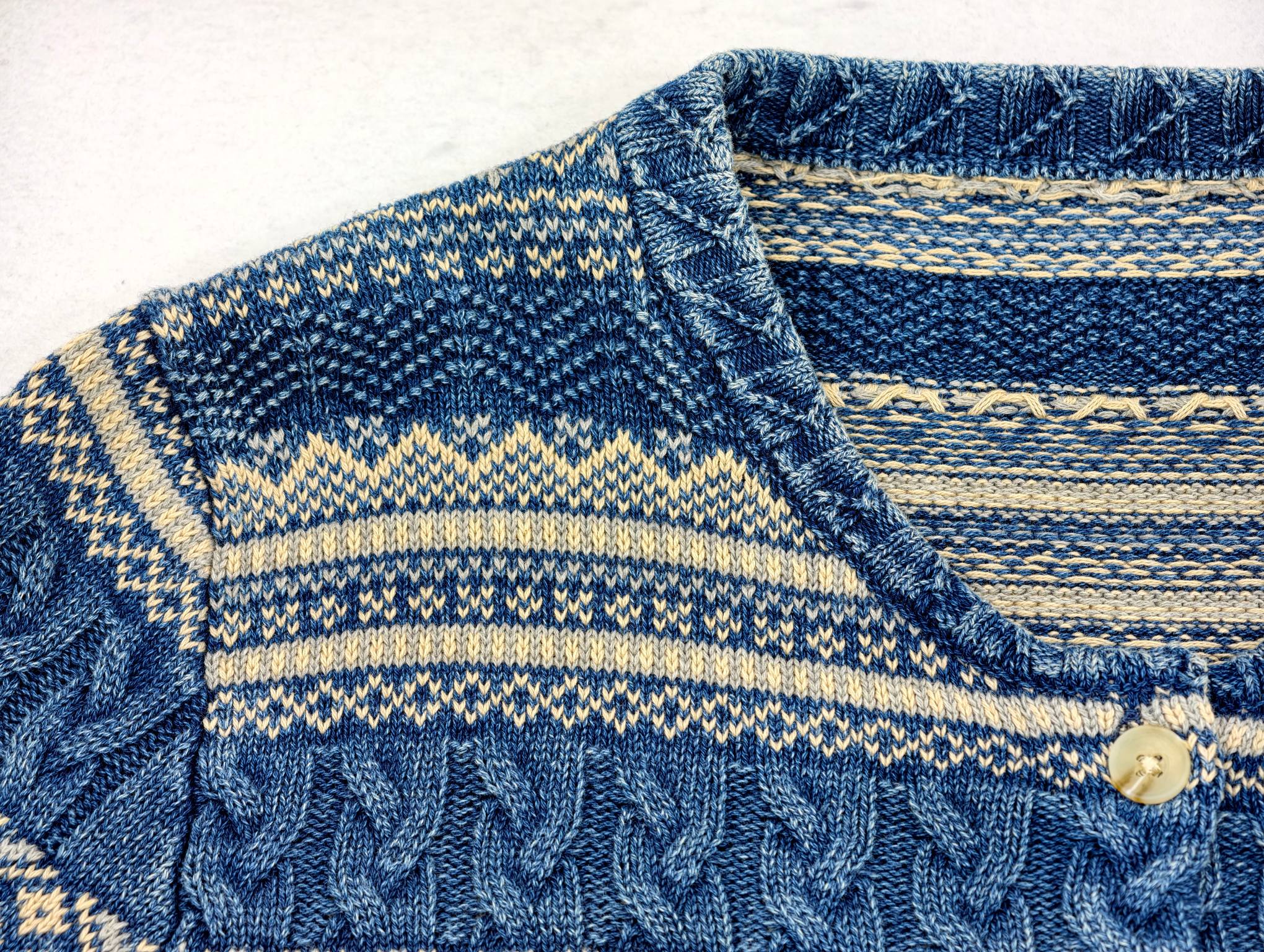 Button placket and folded collar in patterned cotton knit