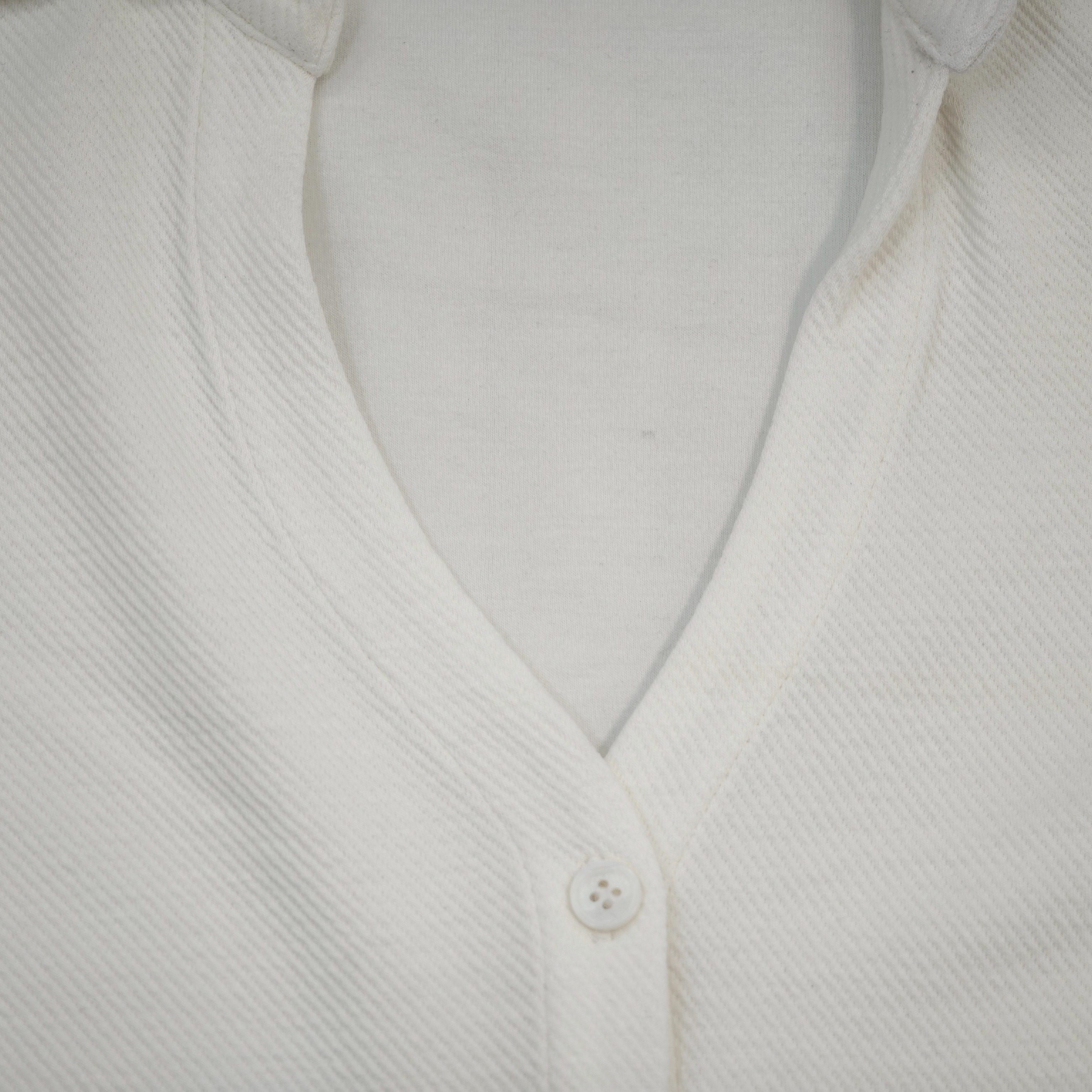 Open collar and tonal button placket construction close-up