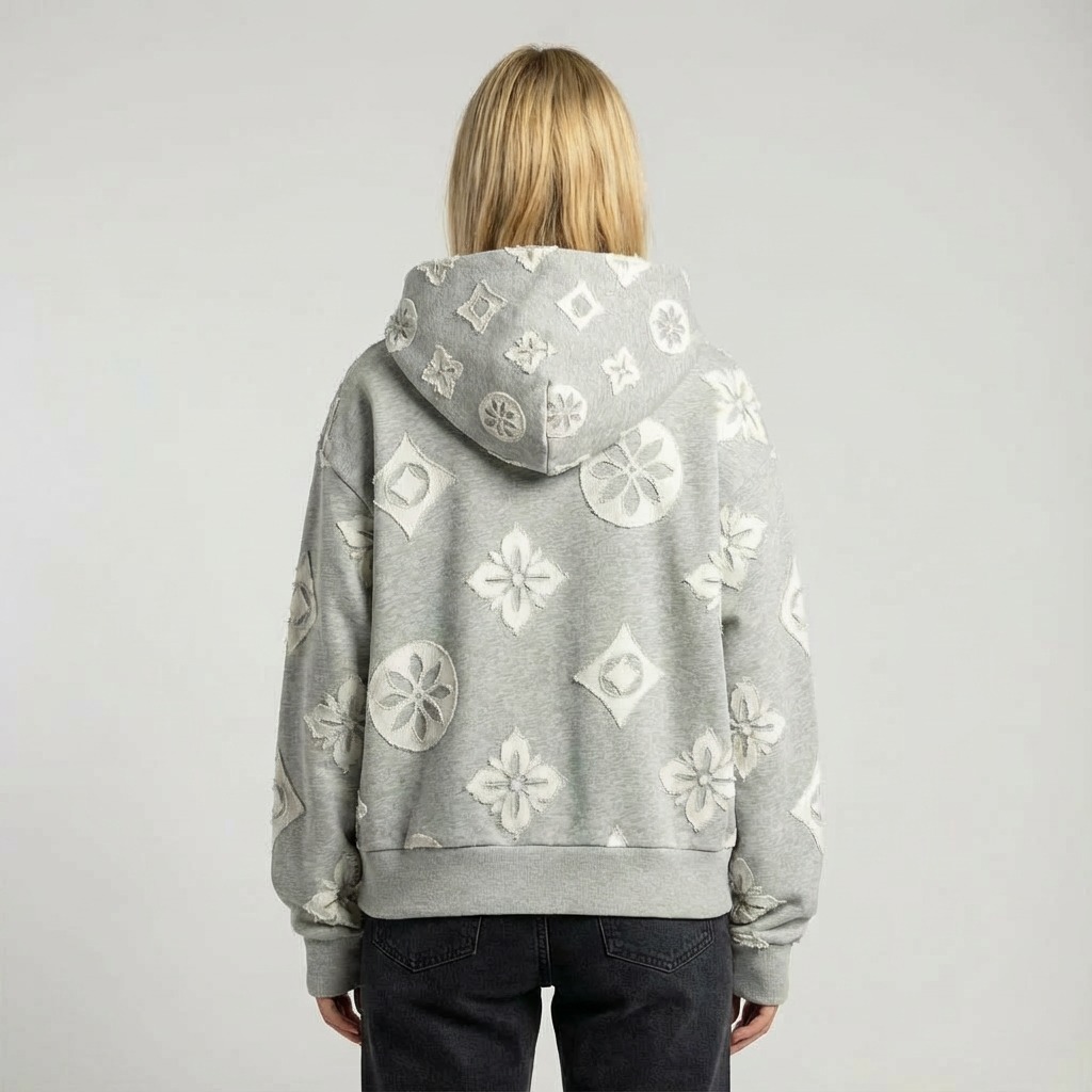 Back view with oversized hood and all-over floral motifs