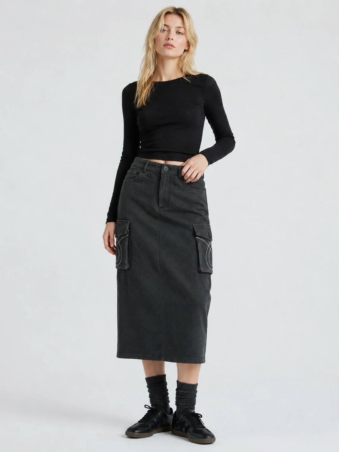 Model wearing washed black embroidered cargo midi skirt