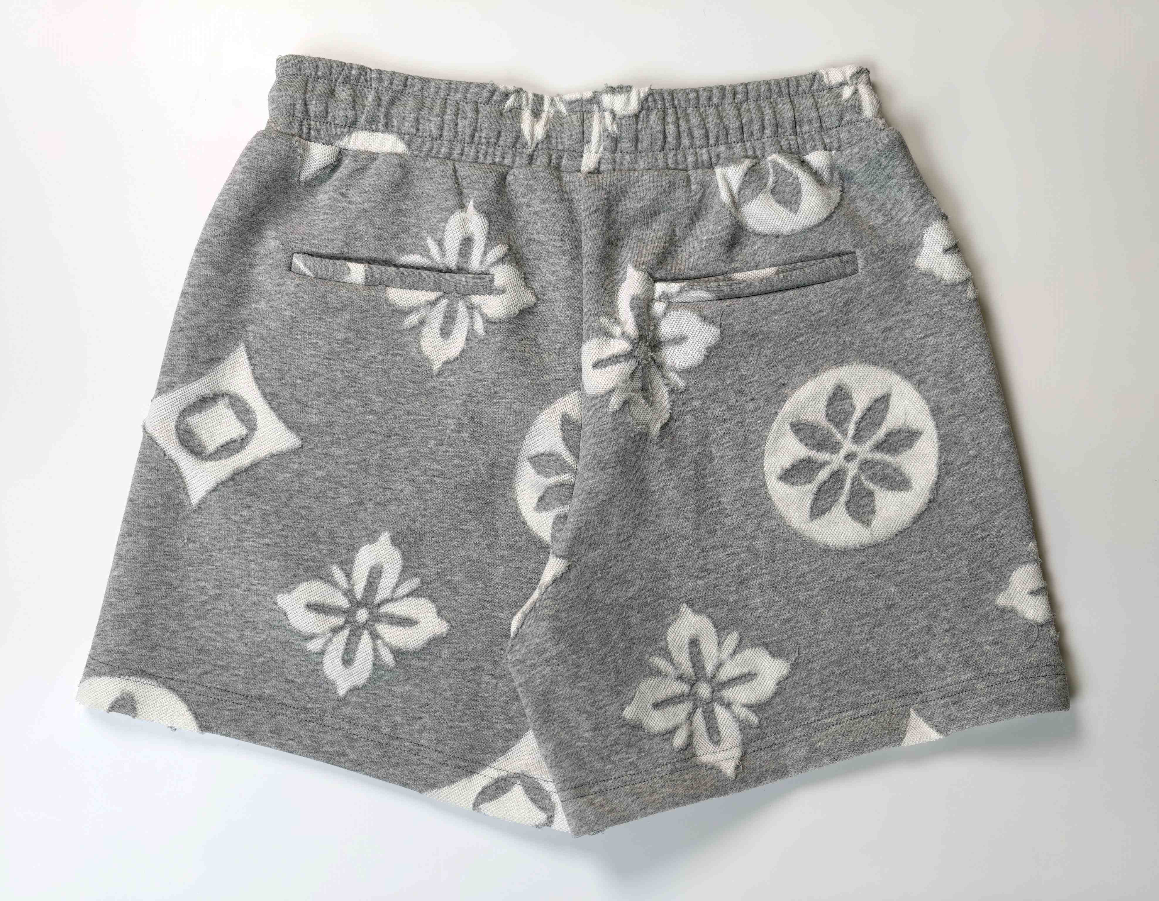 Back view featuring twin pockets and all-over burn-out motifs