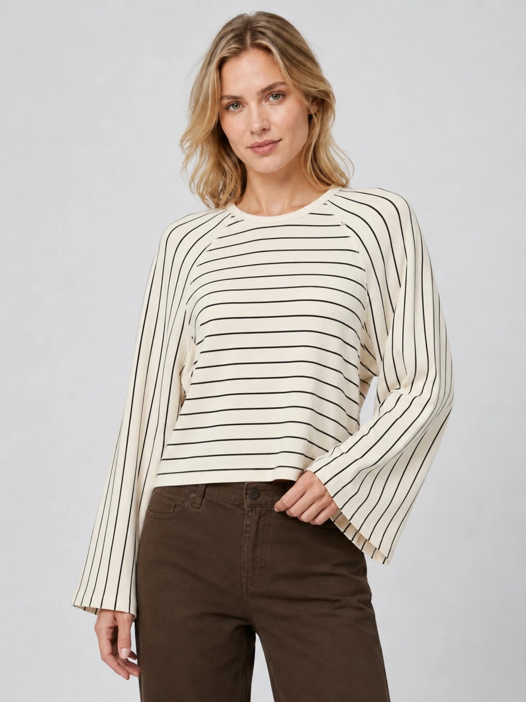 Model wearing ivory striped raglan long-sleeve top