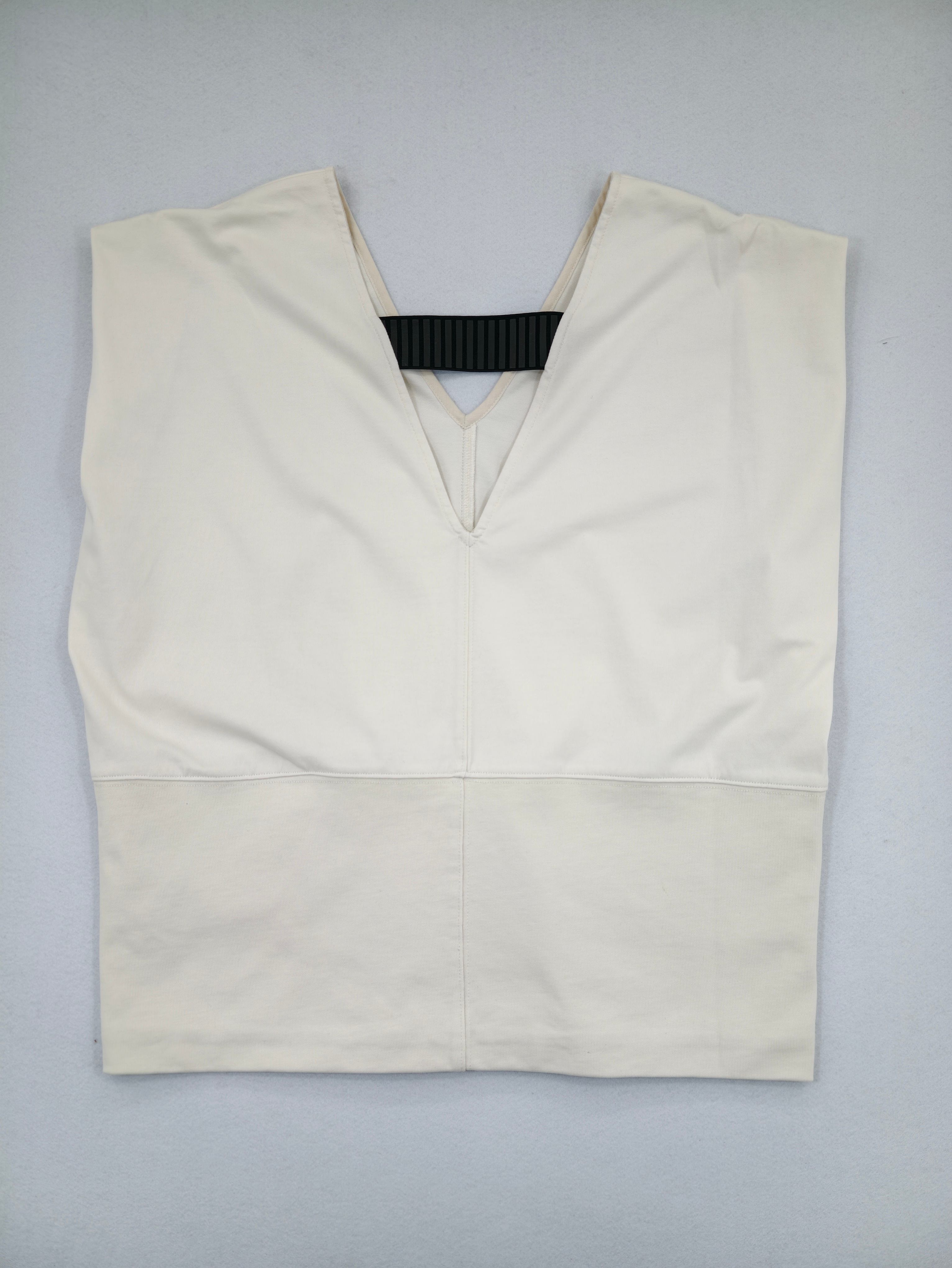 Ivory cutout V-neck sleeveless top laid flat from front