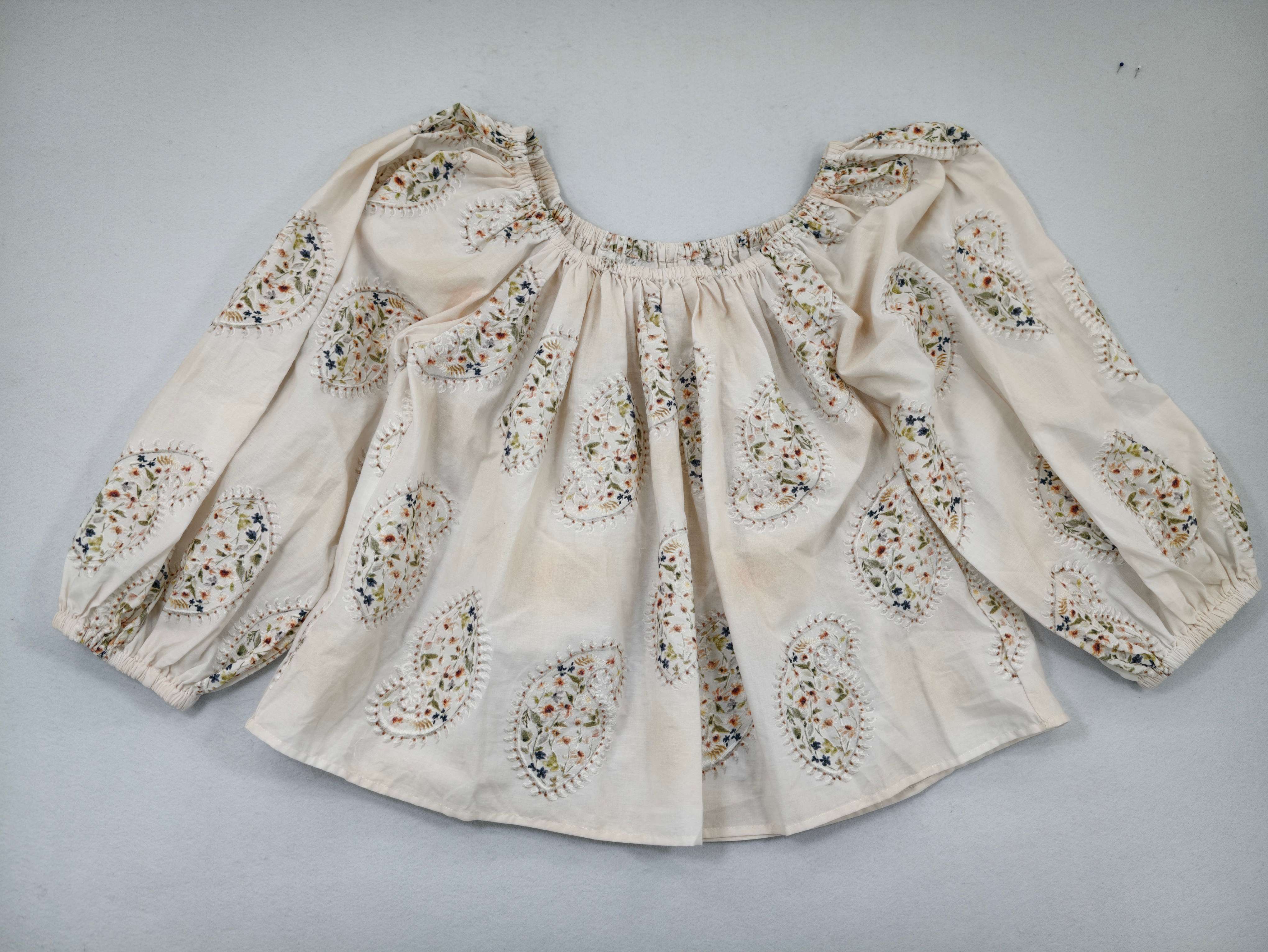Ivory paisley peasant blouse laid flat from front