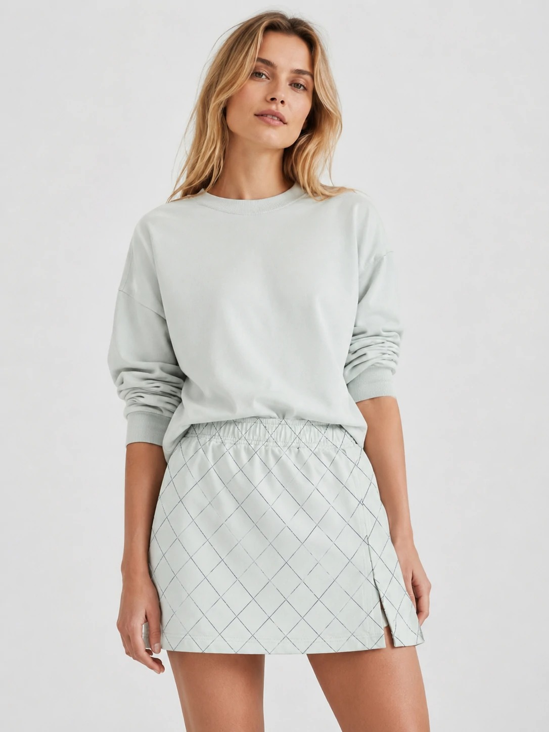 Model wearing light grey grid-print mini skirt